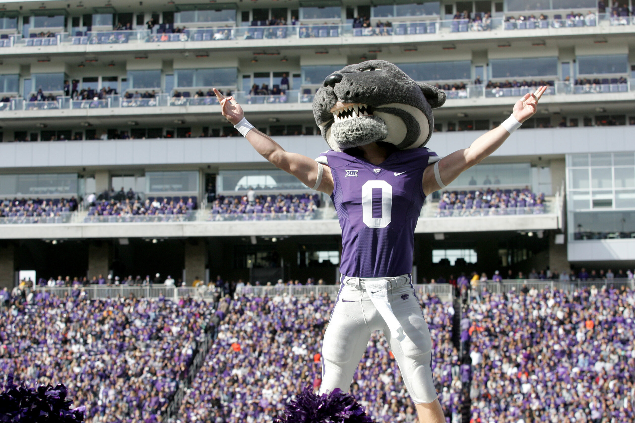 Dec 28, 2023; Orlando, FL, USA; Kansas State quarterback Avery Johnson (2) celebrates his MPV honors with the pop-tart mascot at Camping World Stadium.