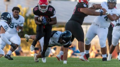 Oak Hills' Karson Cox shakes off a tackle during the first quarter on Friday