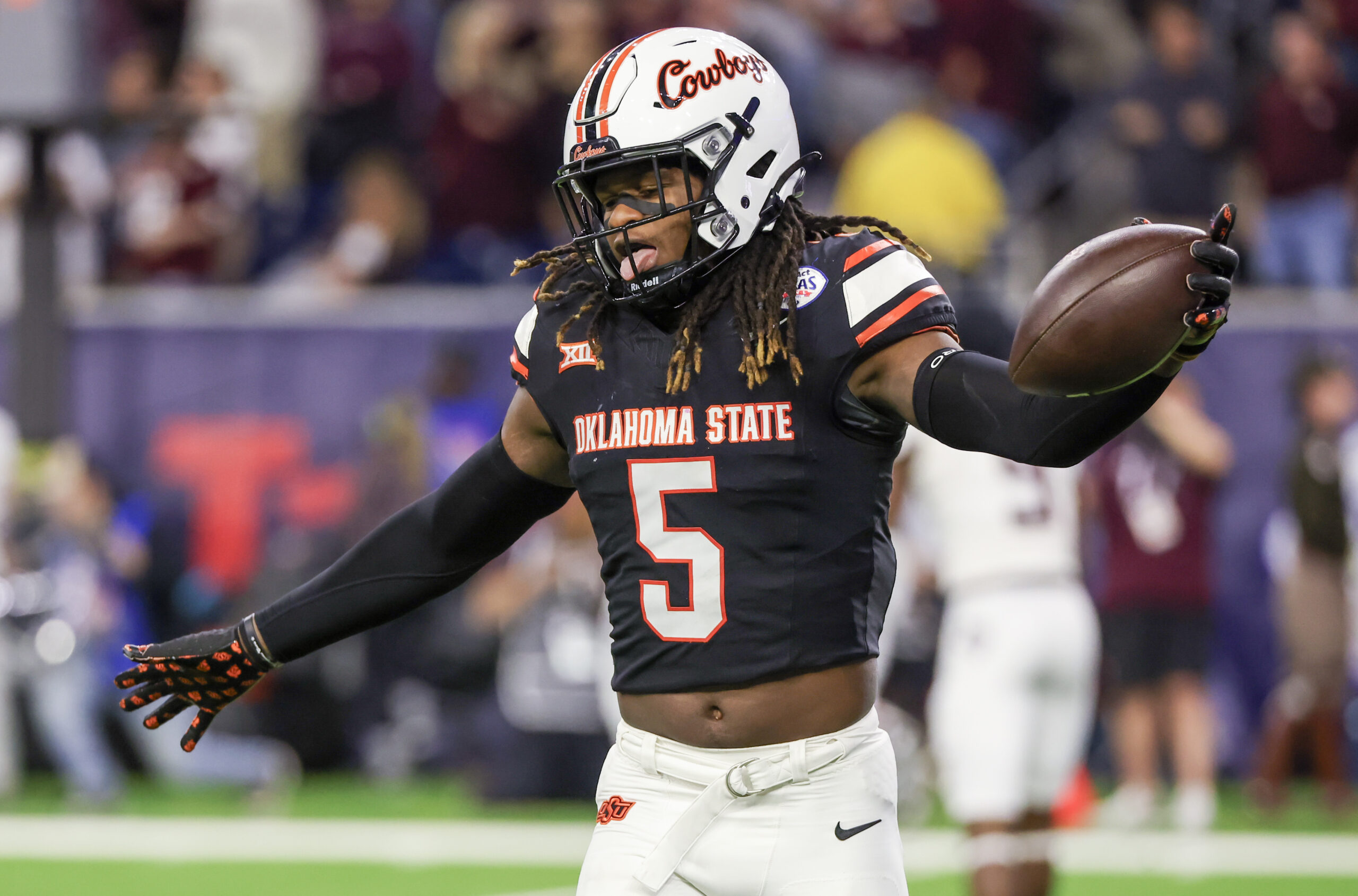 Nov 12, 2022; Stillwater, Oklahoma, USA; Oklahoma State Cowboys safety Kendal Daniels (5) and cornerback Jabbar Muhammad (7) celebrate after a defensive stop against the Iowa State Cyclones in the fourth quarter at Boone Pickens Stadium.