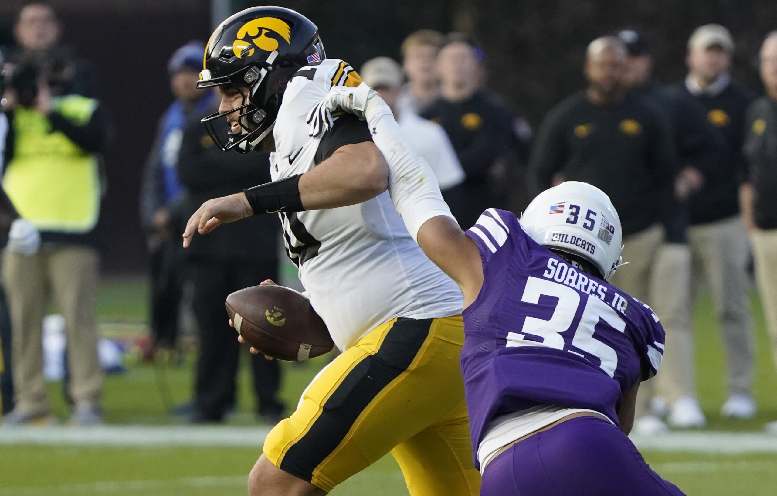 Nov 4, 2023; Chicago, Illinois, USA; Northwestern Wildcats linebacker Kenny Soares Jr. (35) pressures Iowa Hawkeyes quarterback Deacon Hill (10) during the second half at Wrigley Field.