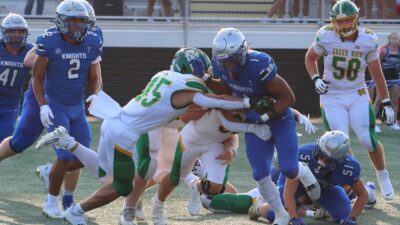 Bishop Ready's Kentrell Rinehart attempts to break the tackle of Newark Catholic's Mikey Hess during the Silver Knights' 53-21 victory in the season opener at Fortress Obetz on Friday