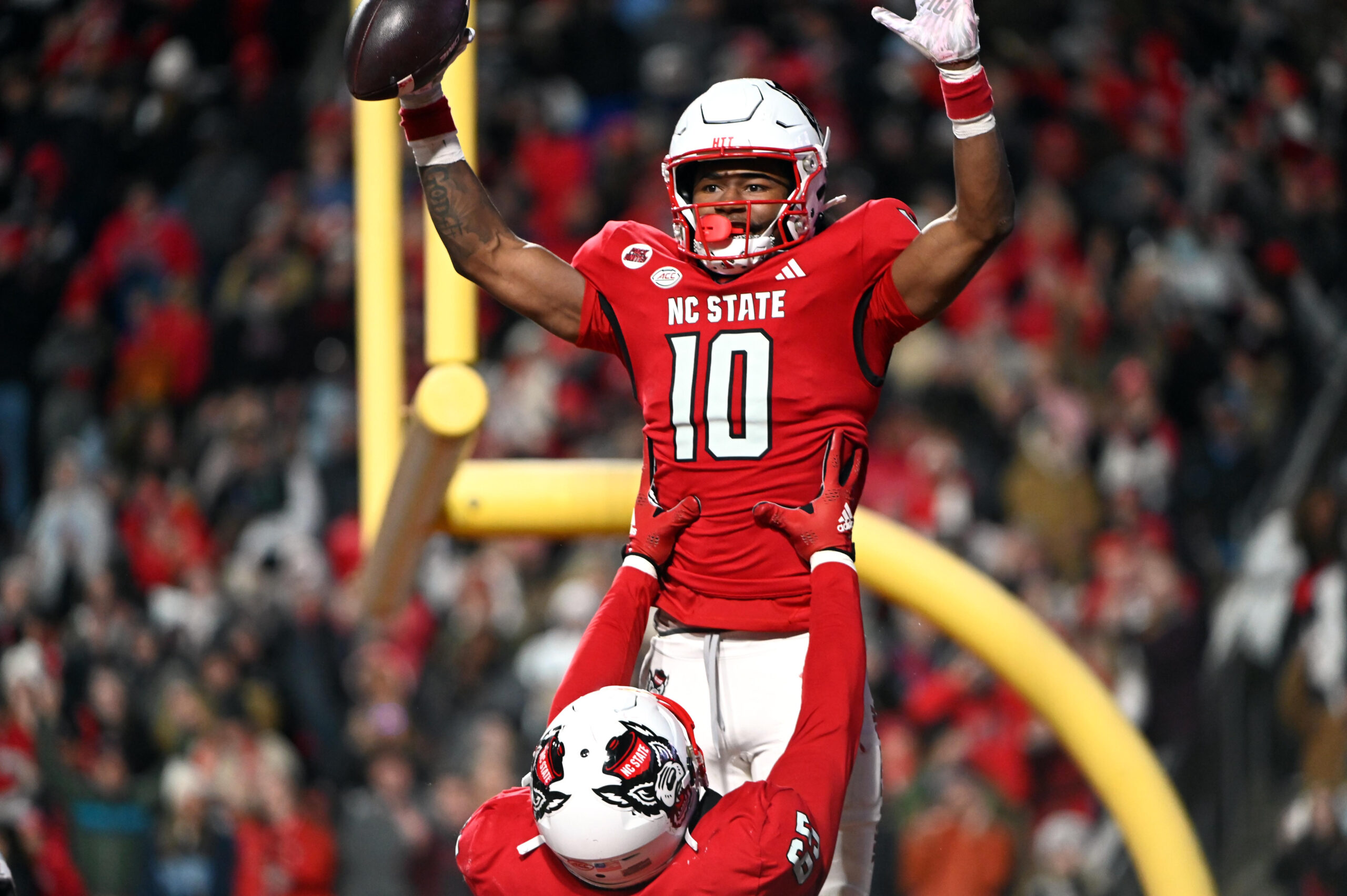 Nov 25, 2023; Raleigh, North Carolina, USA;North Carolina State Wolfpack receiver KC Concepcion (10) celebrates after a touchdown against the North Carolina Tar Heels during the first half at Carter-Finley Stadium