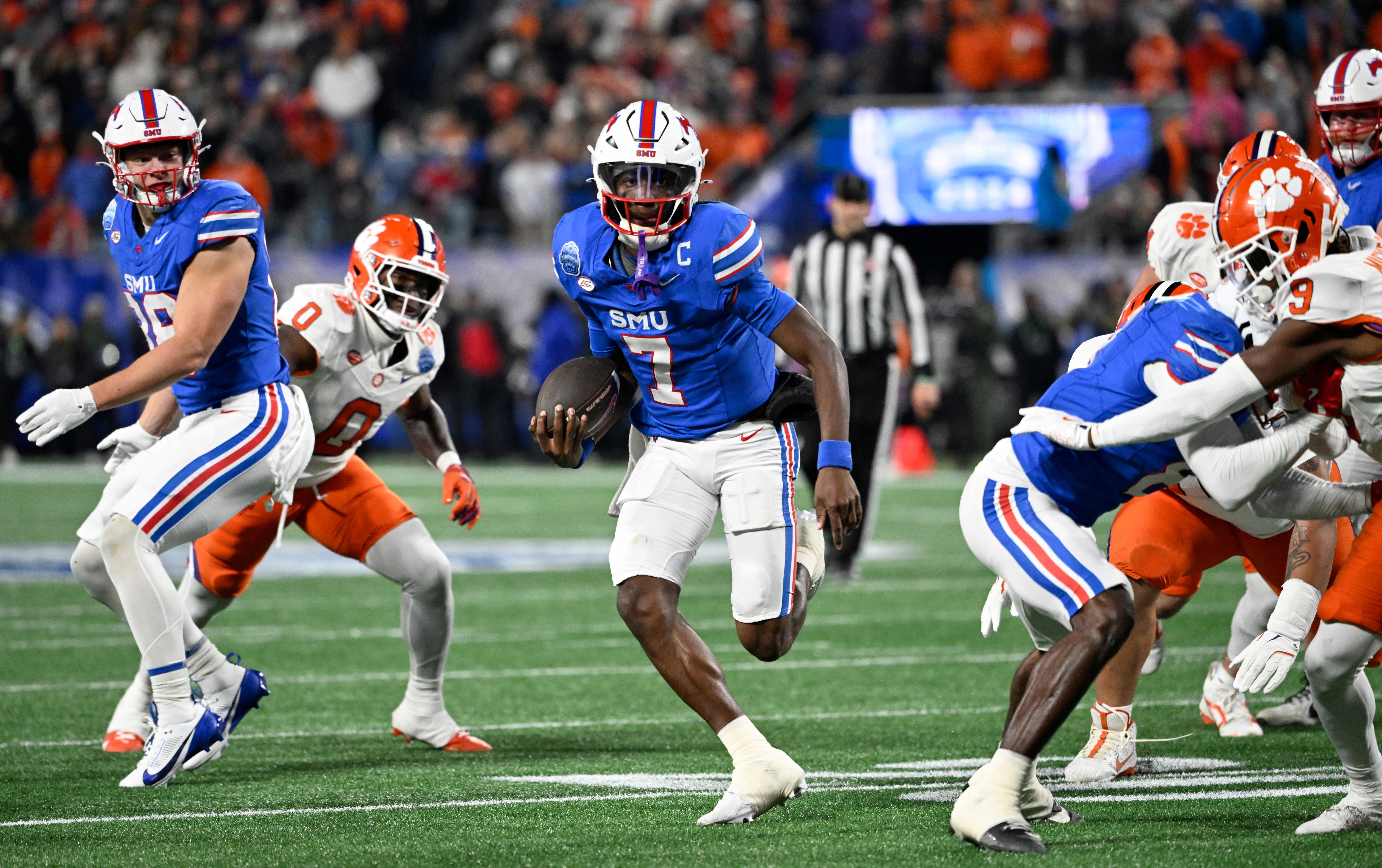Dec 7, 2024; Charlotte, NC, USA; Southern Methodist Mustangs quarterback Kevin Jennings (7) runs for a touchdown during the first quarter against the Clemson Tigers in the 2024 ACC Championship game at Bank of America Stadium.