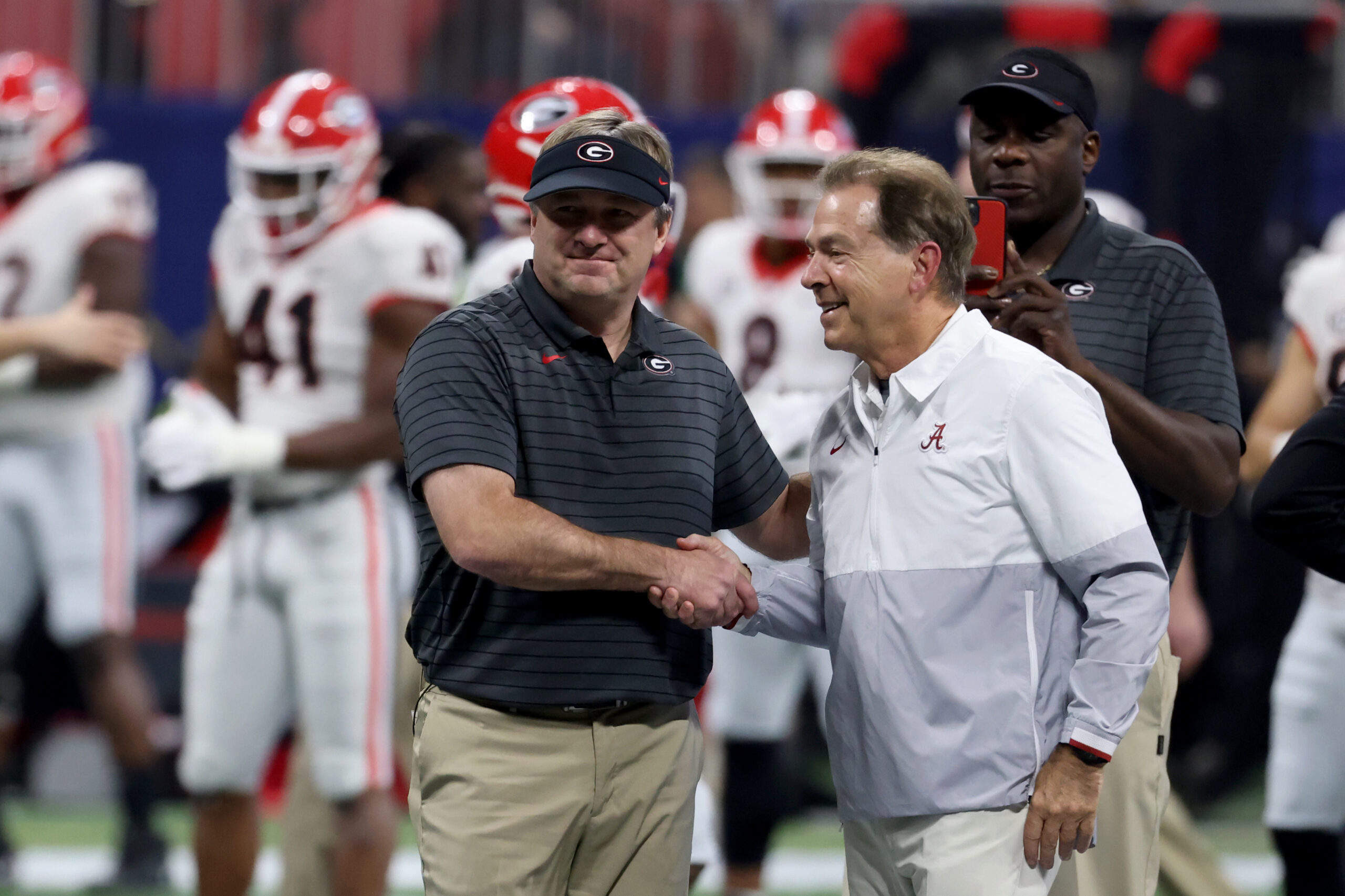 Dec 4, 2021; Atlanta, GA, USA; Georgia Bulldogs head coach Kirby Smart greets Alabama Crimson Tide head coach Nick Saban before the SEC championship game at Mercedes-Benz Stadium.