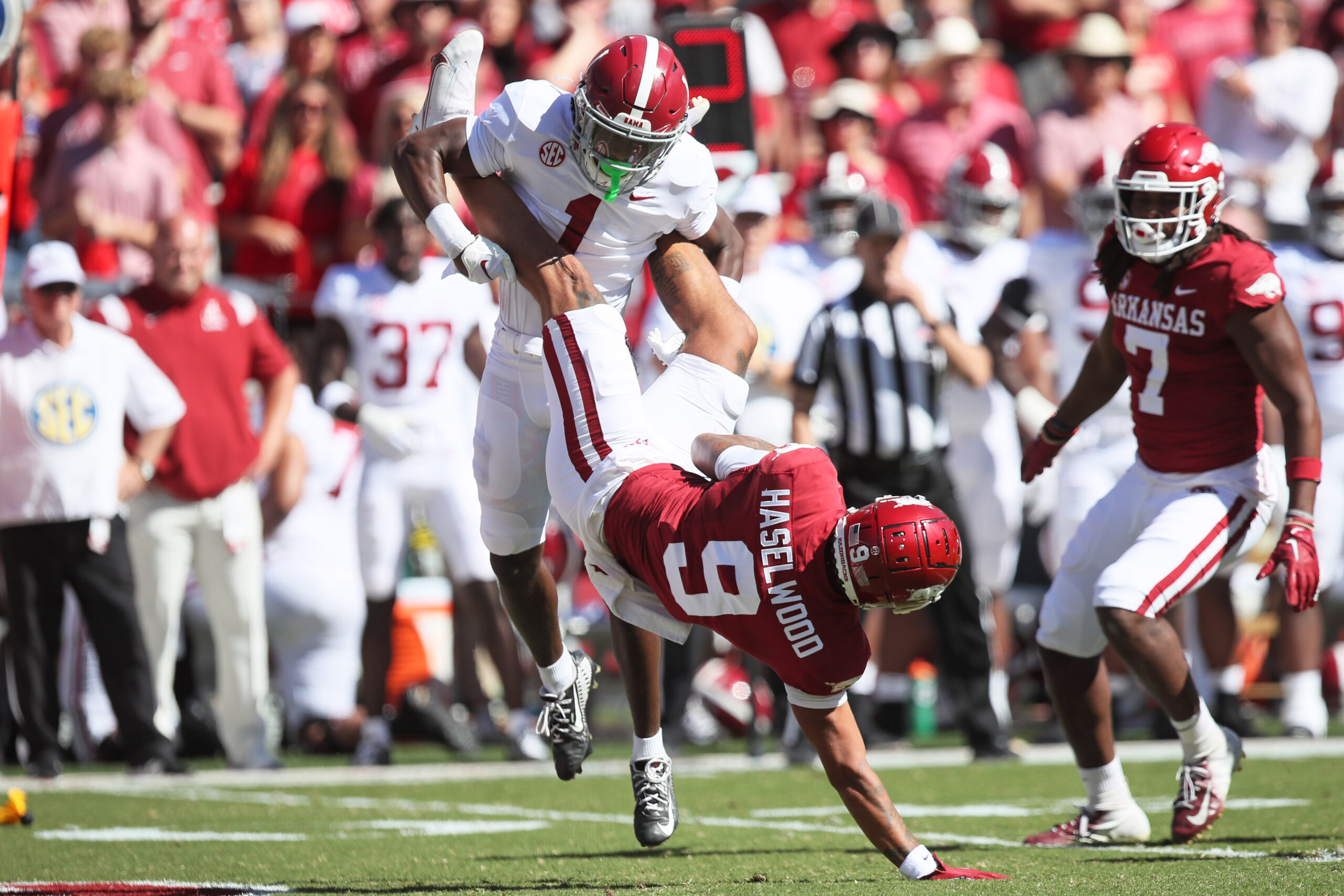 Oct 1, 2022; Fayetteville, Arkansas, USA; Alabama Crimson Tide defensive back Kool-Aid McKinstry (1) tackles Arkansas Razorbacks wide receiver Jadon Haselwood (9) in the first quarter at Donald W. Reynolds Razorback Stadium.