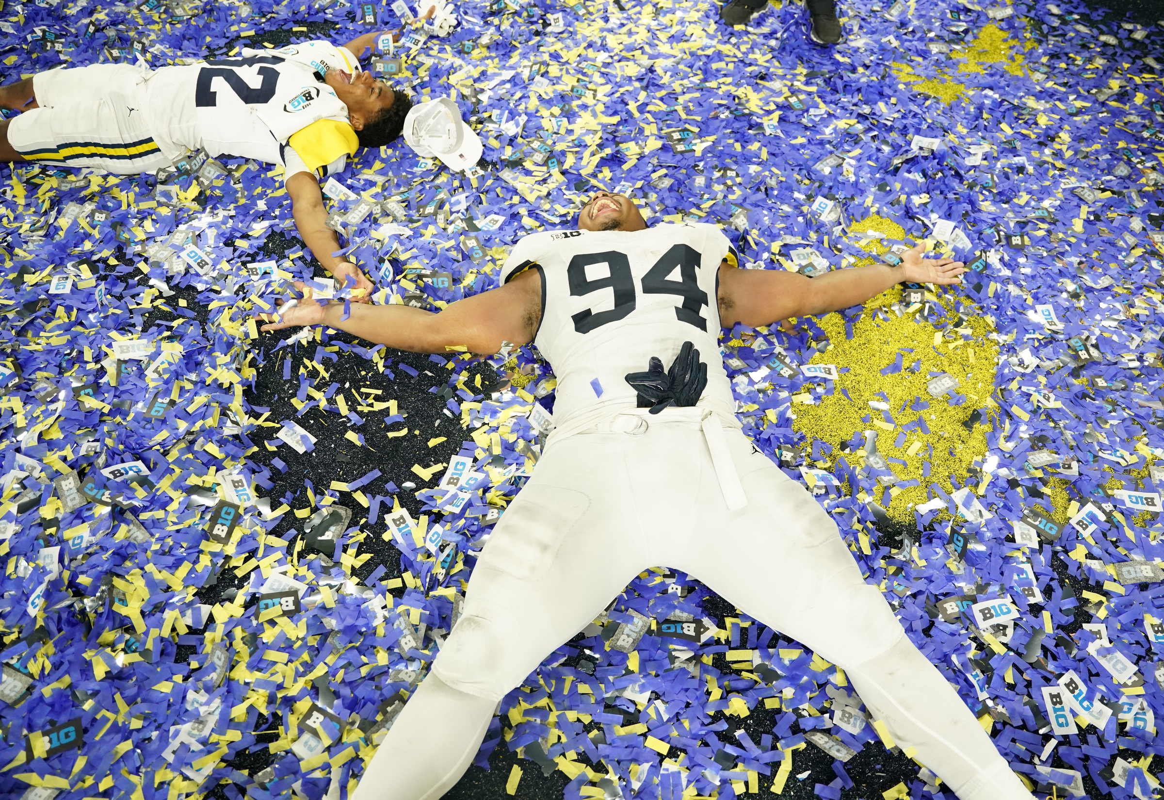 Dec 2, 2023; Indianapolis, IN, USA; Michigan Wolverines wide receiver Semaj Morgan (82) and defensive lineman Kris Jenkins (94) celebrate after winning the Big Ten Championship game against the Iowa Hawkeyes at Lucas Oil Stadium.