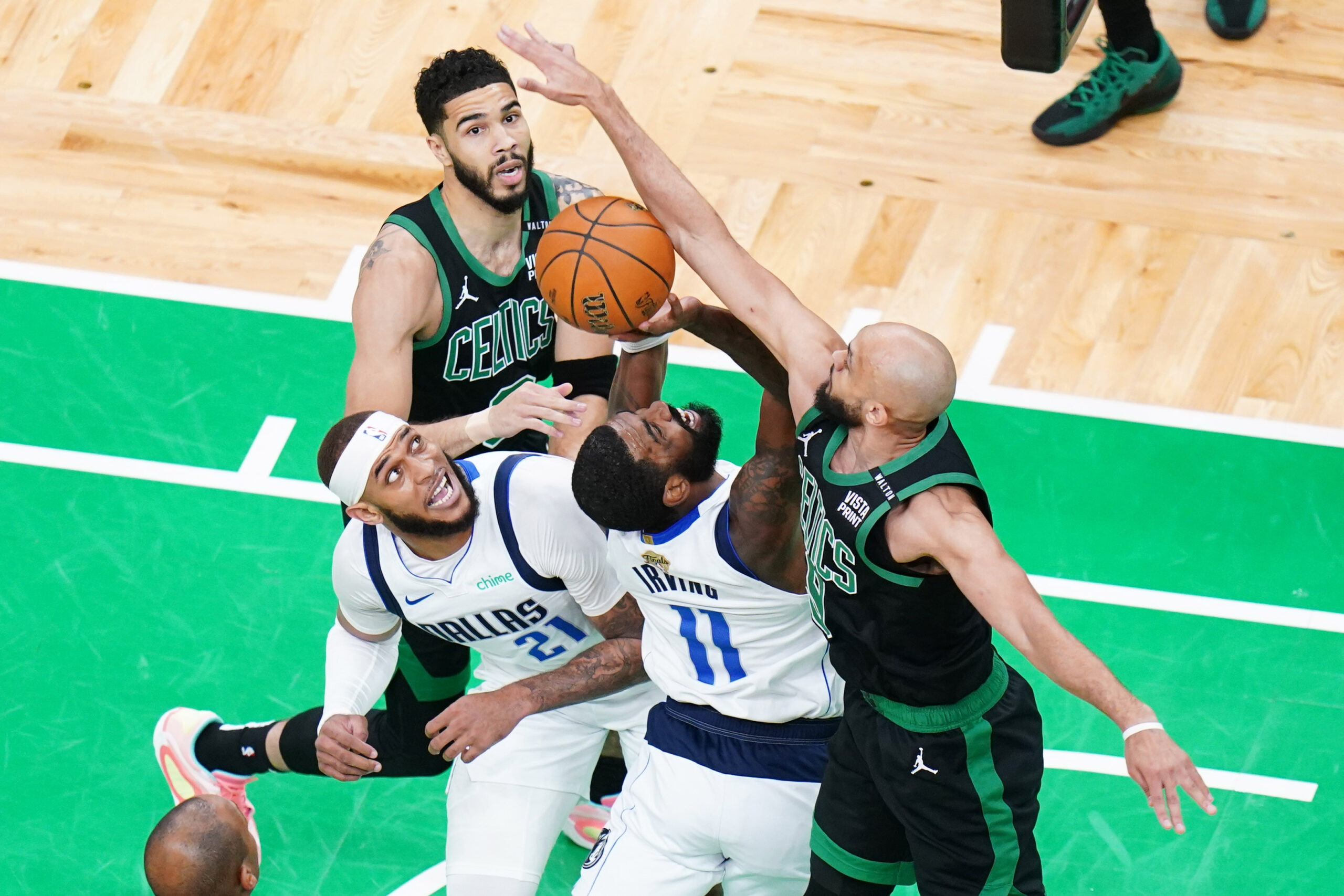 Jun 9, 2024; Boston, Massachusetts, USA; Boston Celtics guard Derrick White (9) blocks Dallas Mavericks guard Kyrie Irving (11) in the first quarter during game two of the 2024 NBA Finals at TD Garden.
