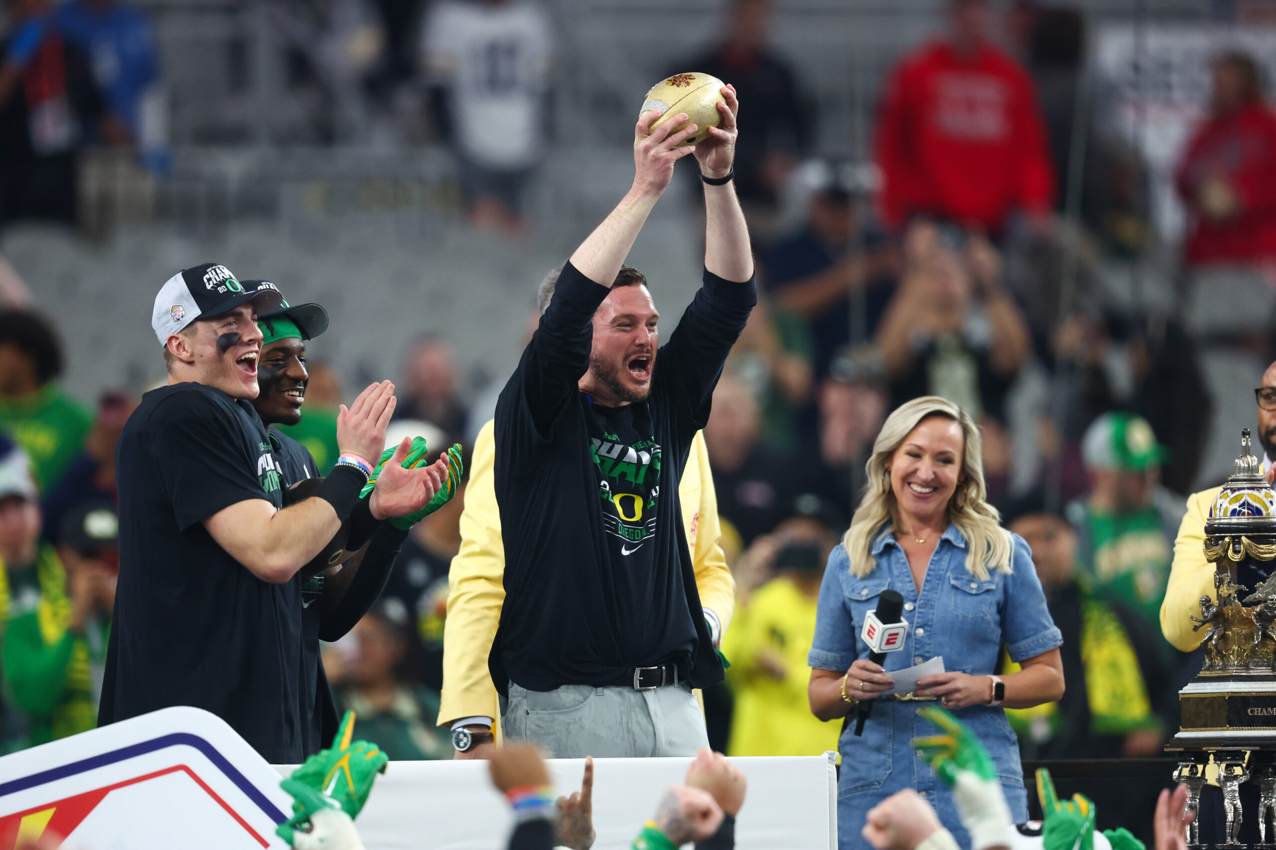 Jan 1, 2024; Glendale, AZ, USA; Oregon Ducks head coach Dan Lanning lifts the Fiesta Bowl trophy after a victory against the Liberty Flames in the 2024 Fiesta Bowl at State Farm Stadium. The Ducks won 45-6.