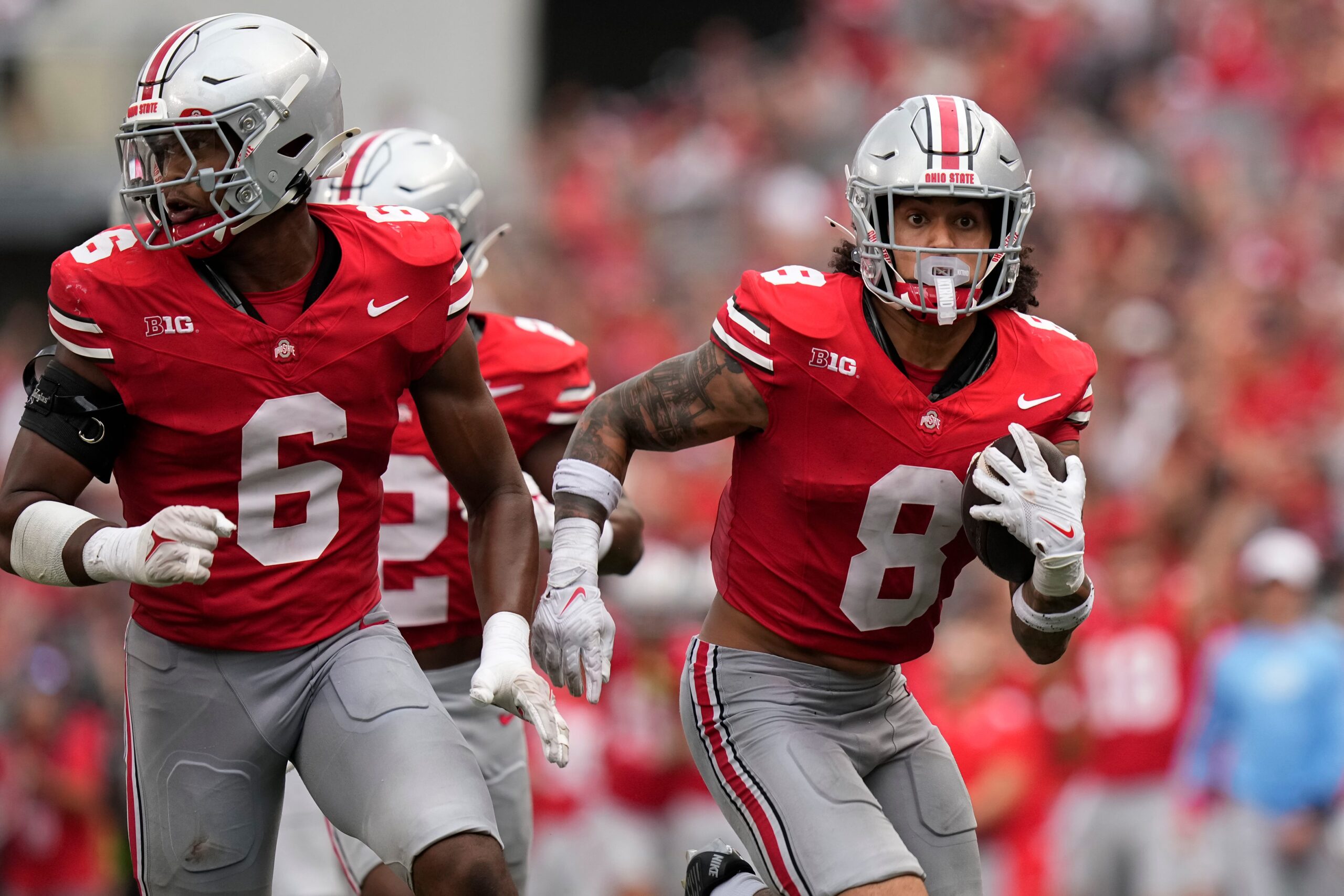Aug 31, 2024; Columbus, OH, USA; Ohio State Buckeyes safety Lathan Ransom (8) scoops up a fumble and returns it for a touchdown behind the blocking of safety Sonny Styles (6) during the second half of the NCAA football game against the Akron Zips at Ohio Stadium. Ohio State won 52-6.  
