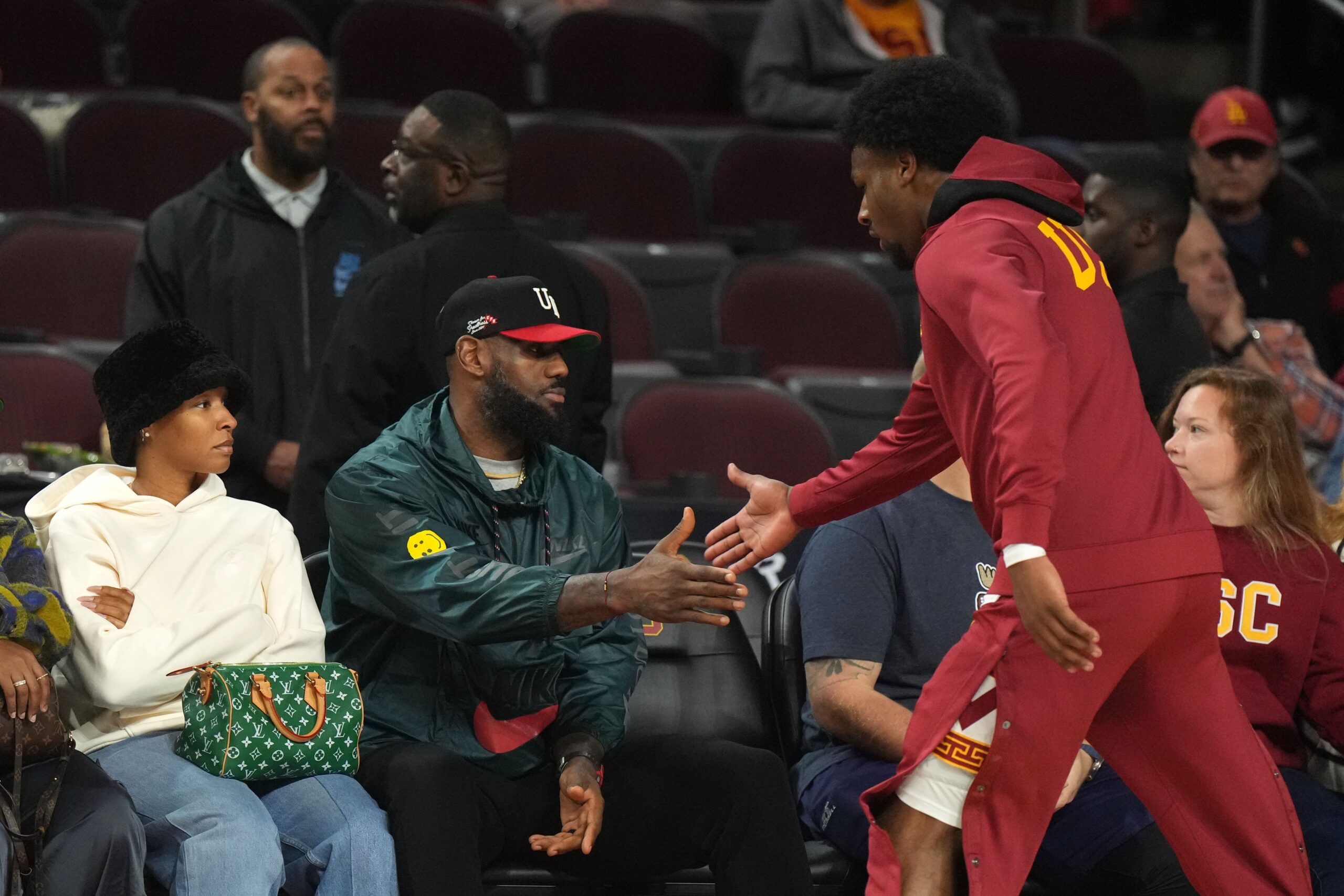 Jan 10, 2024; Los Angeles, California, USA; Southern California Trojans guard Bronny James (6) is greeted by father LeBron James during the game against the Washington State Cougars at Galen Center.