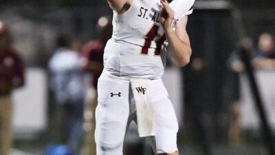 St. Augustine's quarterback Locklan Hewlett (11) targets a receiver during first-quarter action. The St. Augustine Yellow Jackets traveled to Nease High School's Panther Stadium for Friday night's Saint Johns County high school football rivalry game on October 6