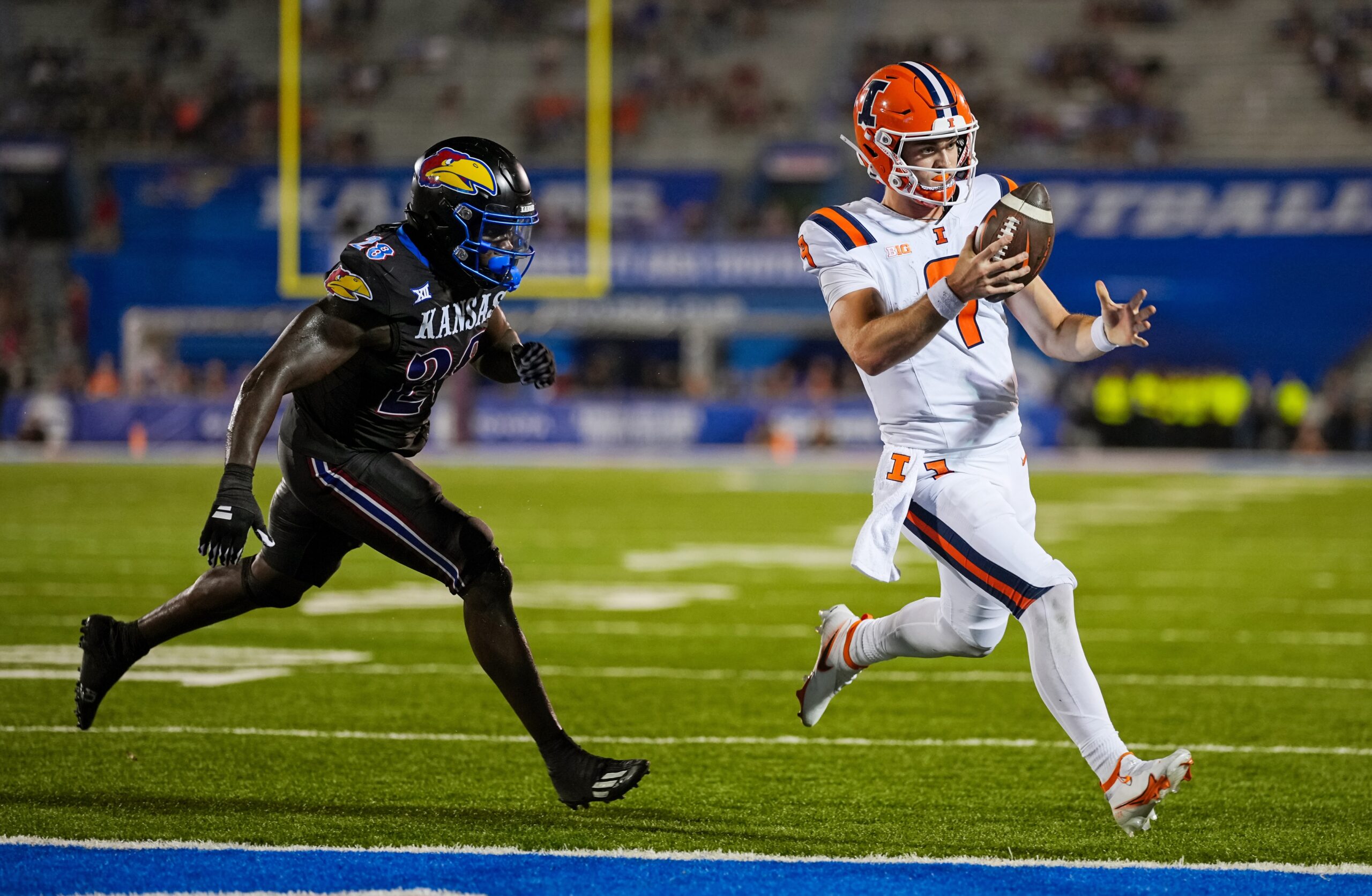 Sep 8, 2023; Lawrence, Kansas, USA; Illinois Fighting Illini quarterback Luke Altmyer (9) runs for a touchdown against Kansas Jayhawks linebacker JB Brown (28) during the second half at David Booth Kansas Memorial Stadium.