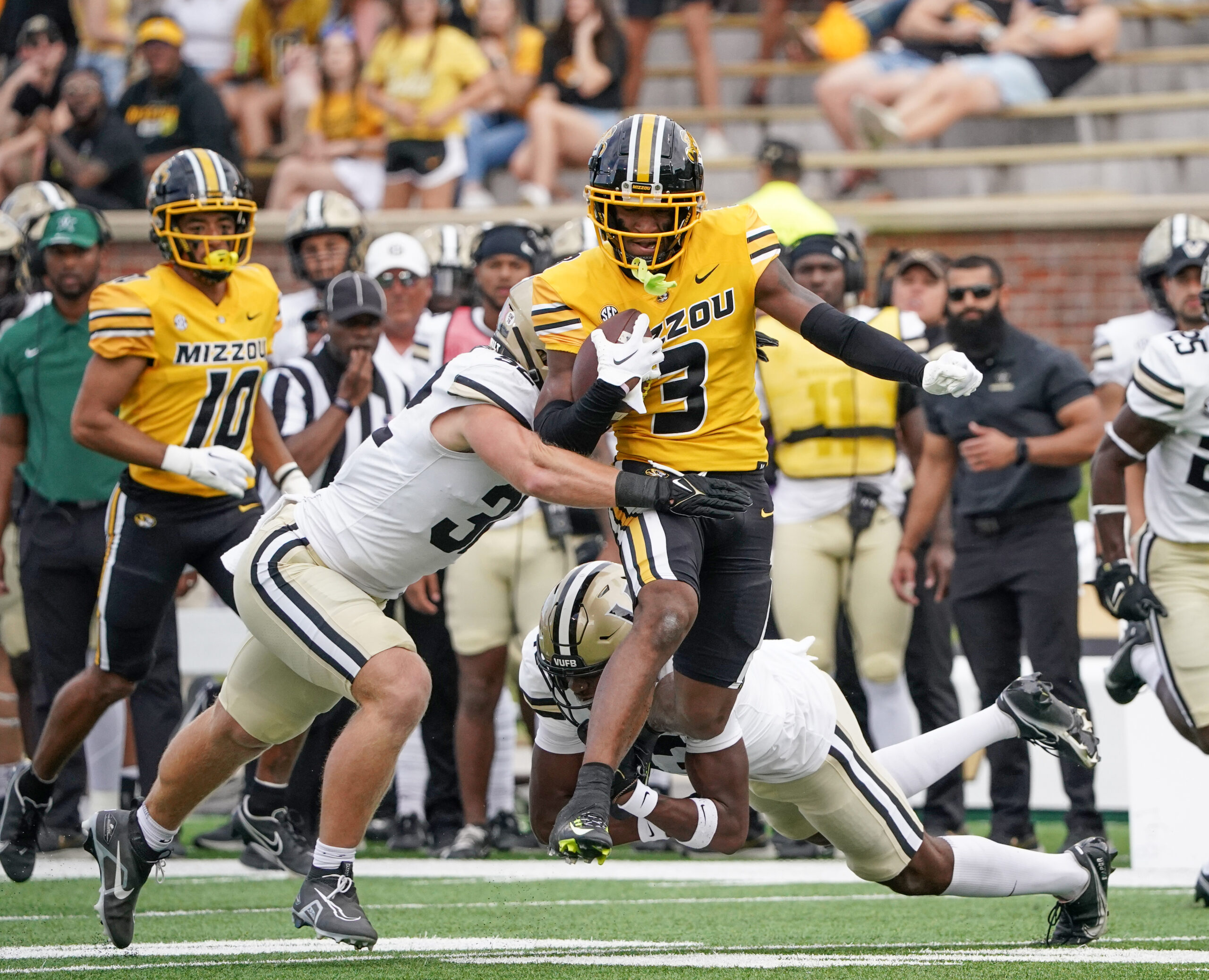 Oct 22, 2022; Columbia, Missouri, USA; Missouri Tigers wide receiver Luther Burden III (3) runs the ball as Vanderbilt Commodores linebacker Ethan Barr (32) attempts the tackle during the first half of the game at Faurot Field at Memorial Stadium.