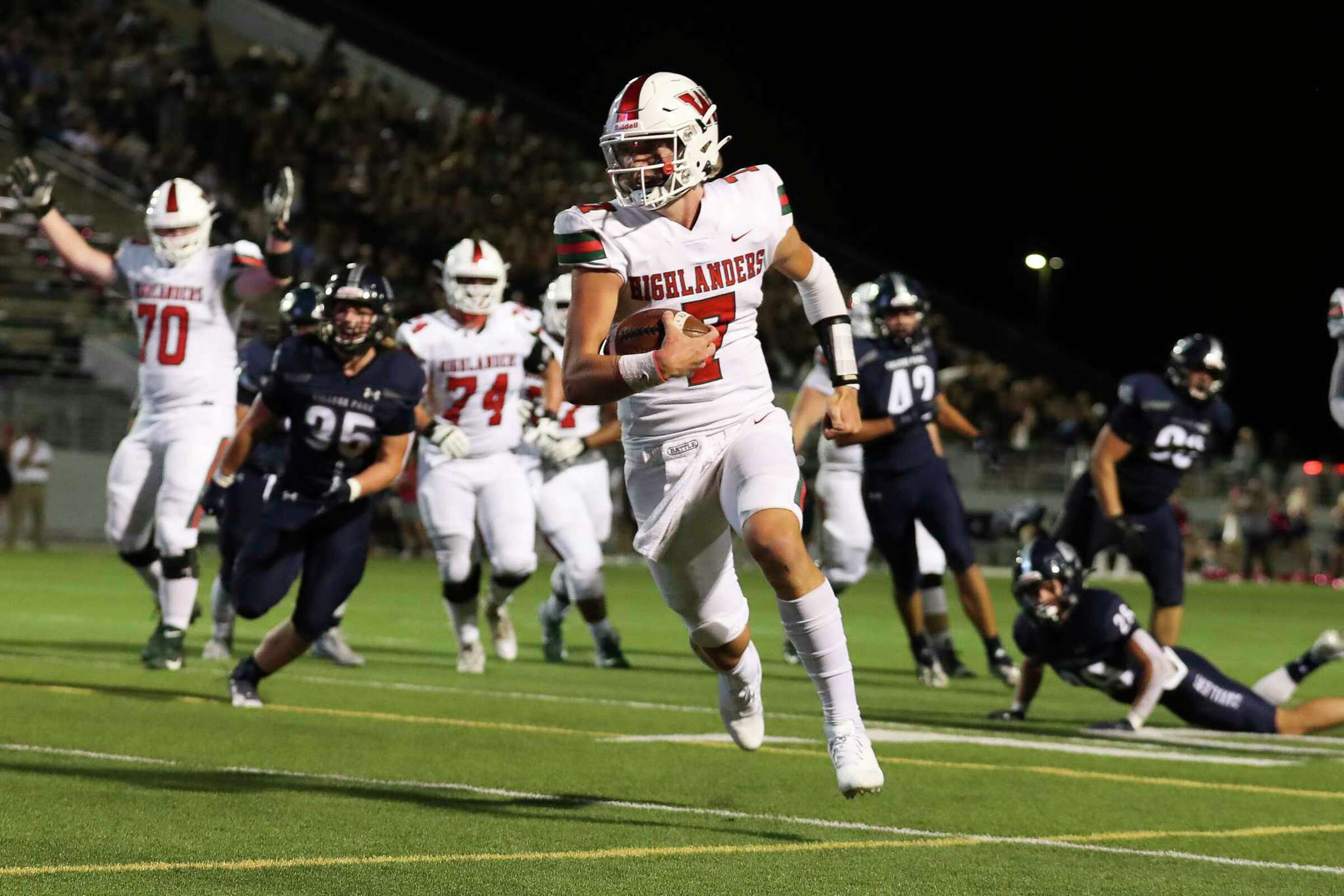 The Woodlands quarterback Mabrey Mettauer runs for a touchdown during the first half of a Region II-6A Division I area high school football playoff game against Klein Cain, Friday, Nov. 18, 2022, in The Woodlands.