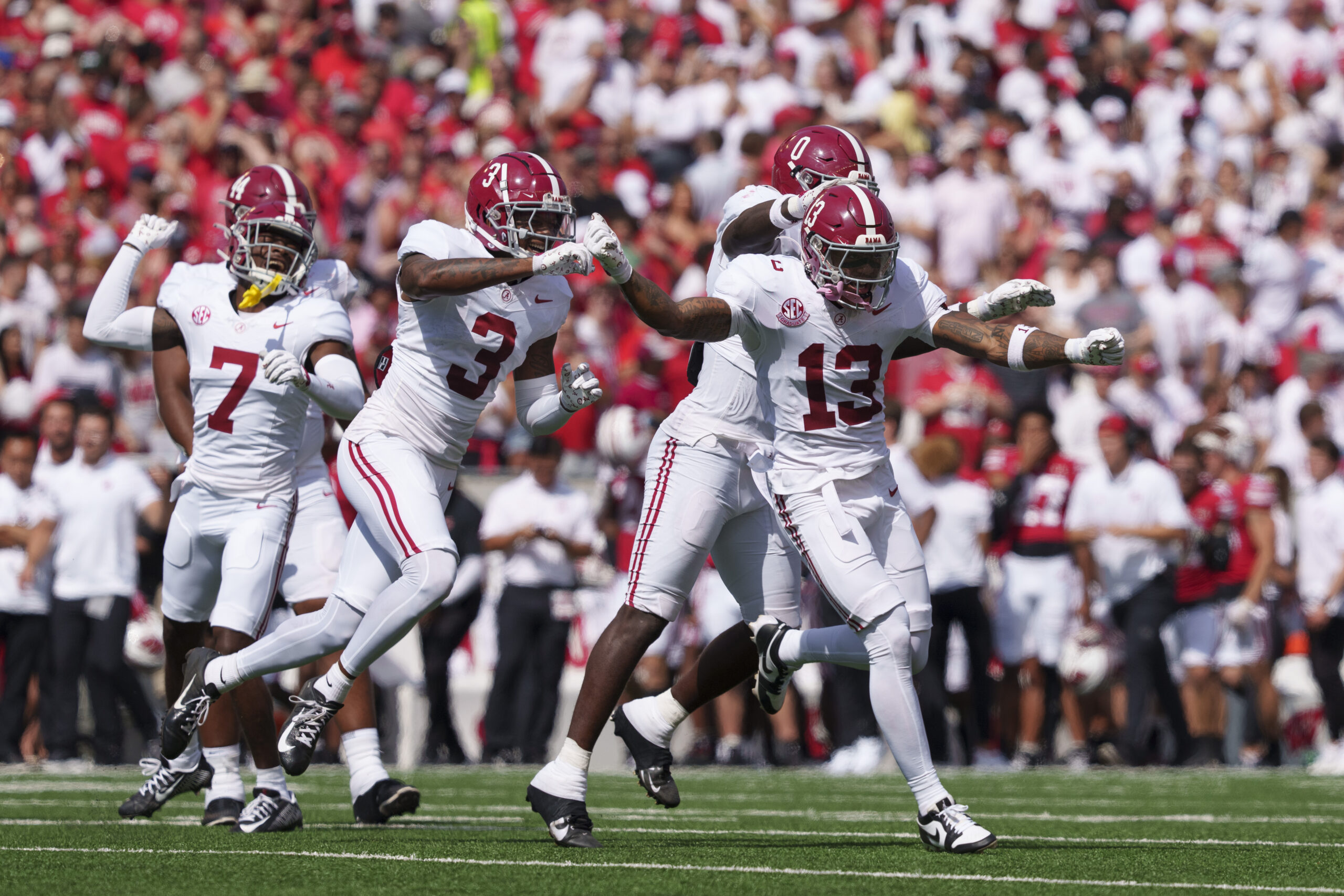 Sep 14, 2024; Madison, Wisconsin, USA; Alabama Crimson Tide quarterback Jalen Milroe (4) scores a touchdown in 10-yard run against Wisconsin Badgers safety Hunter Wohler (24) during the third quarter at Camp Randall Stadium. Alabama won 42-10. 