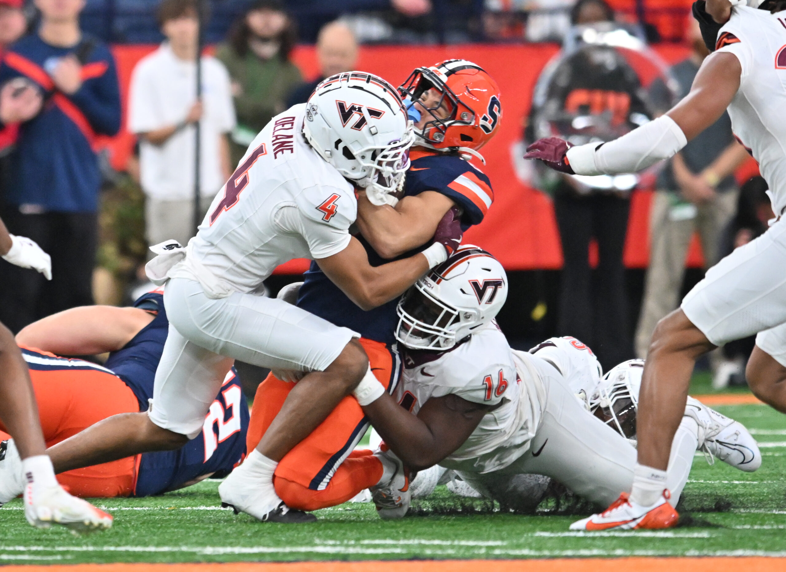 Nov 2, 2024; Syracuse, New York, USA; Syracuse Orange wide receiver Trebor Pena (2) is tackled by Virginia Tech Hokies cornerback Mansoor Delane (4) and cornerback Jonathan Pennix (14) in the first quarter at JMA Wireless Dome. 