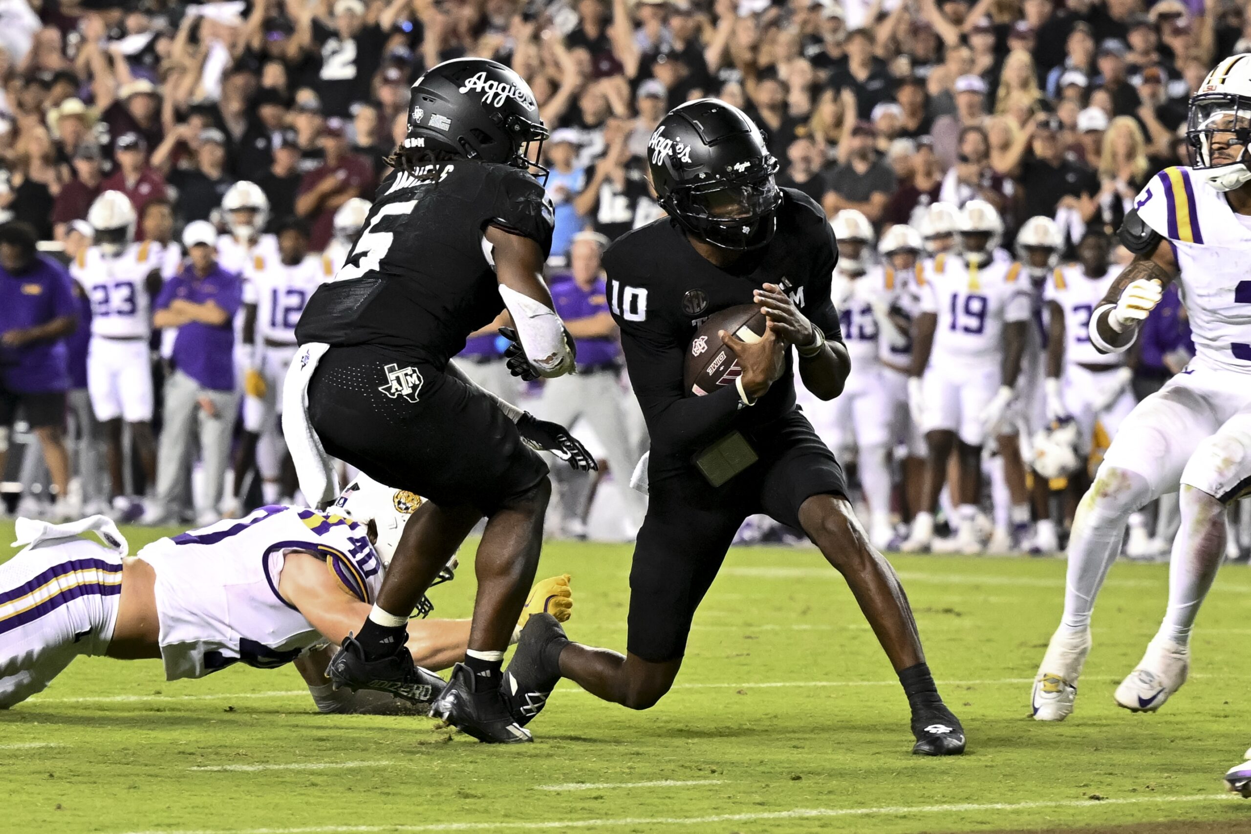 Oct 26, 2024; College Station, Texas, USA; Texas A&M Aggies quarterback Marcel Reed (10) runs the ball in for a touchdown in the third quarter against the LSU Tigers at Kyle Field.