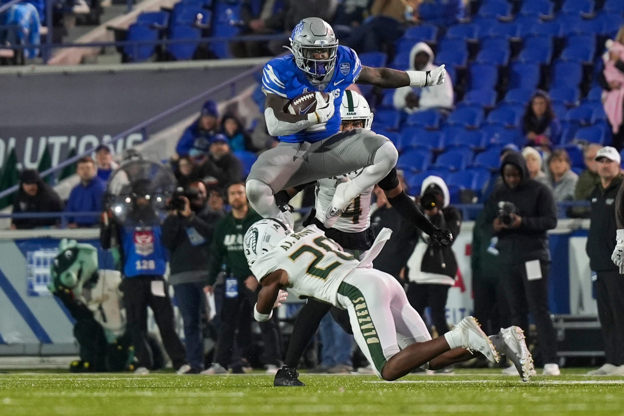 Memphis' Mario Anderson Jr. (2) hurdles UAB's AJ Brown (20) while running with the ball during the game between UAB and the University of Memphis at Simmons Bank Liberty Stadium in Memphis, Tenn., on Saturday, November 16, 2024.