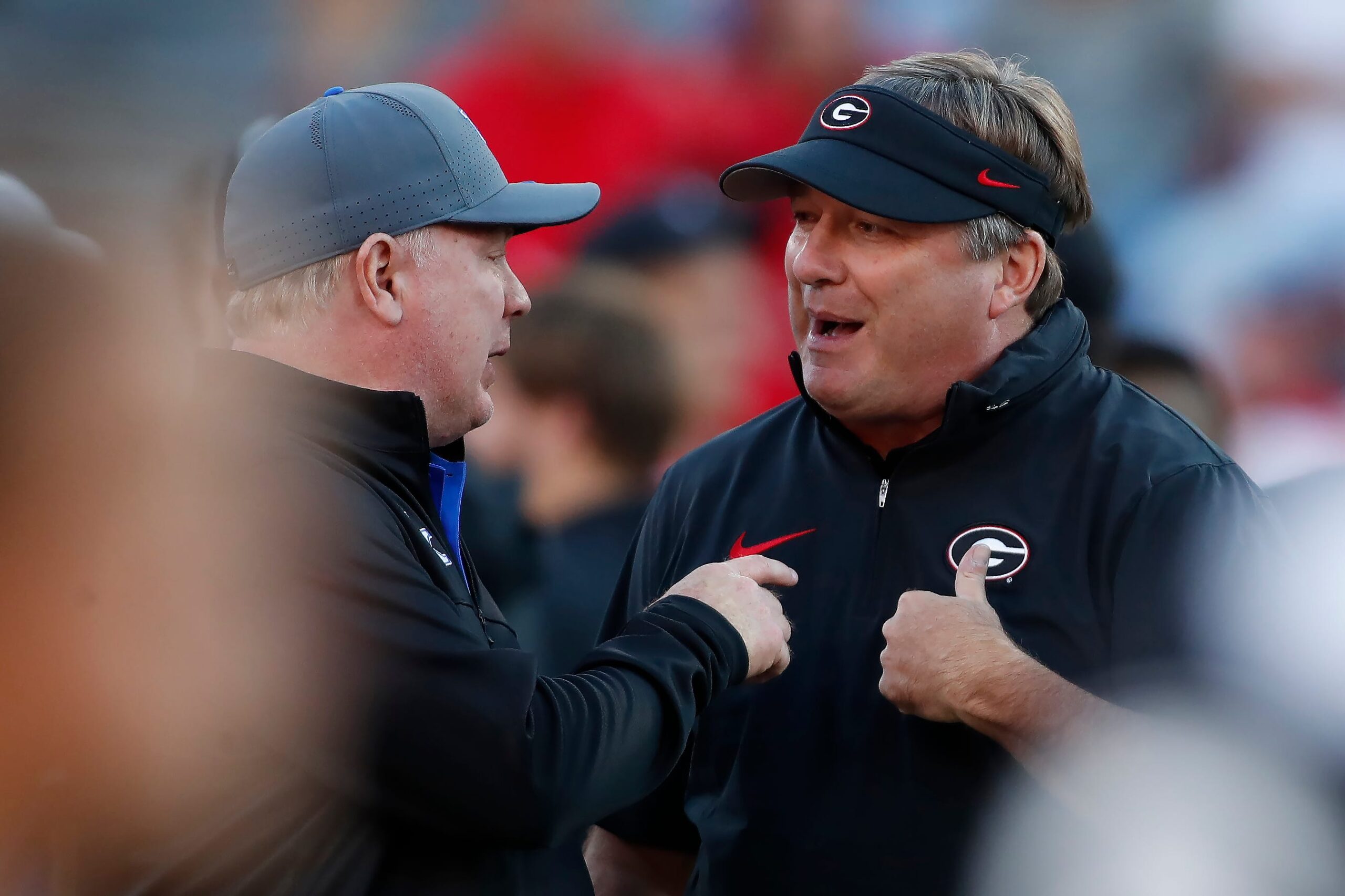 Georgia coach Kirby Smart speaks with Kentucky coach Mark Stoops before the start of a NCAA college football game against Kentucky in Athens, Ga., on Saturday, Oct. 7, 2023.