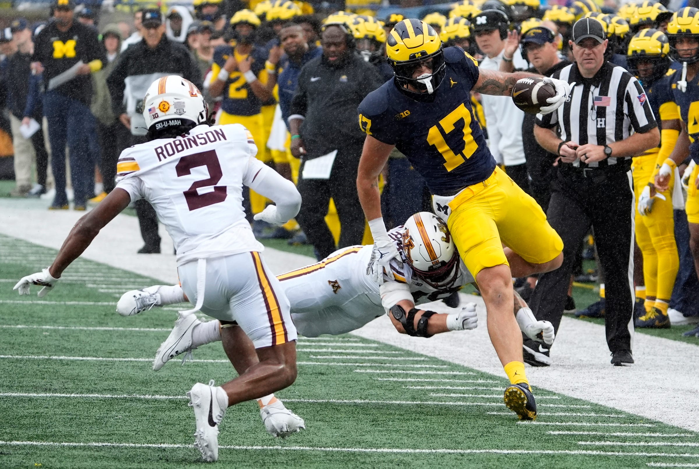 Michigan tight end Marlin Klein gets knocked out of bounds after catching the football for extra yardage during first-half action between Michigan and Minnesota at Michigan Stadium in Ann Arbor on Saturday, Sept. 28, 2024.