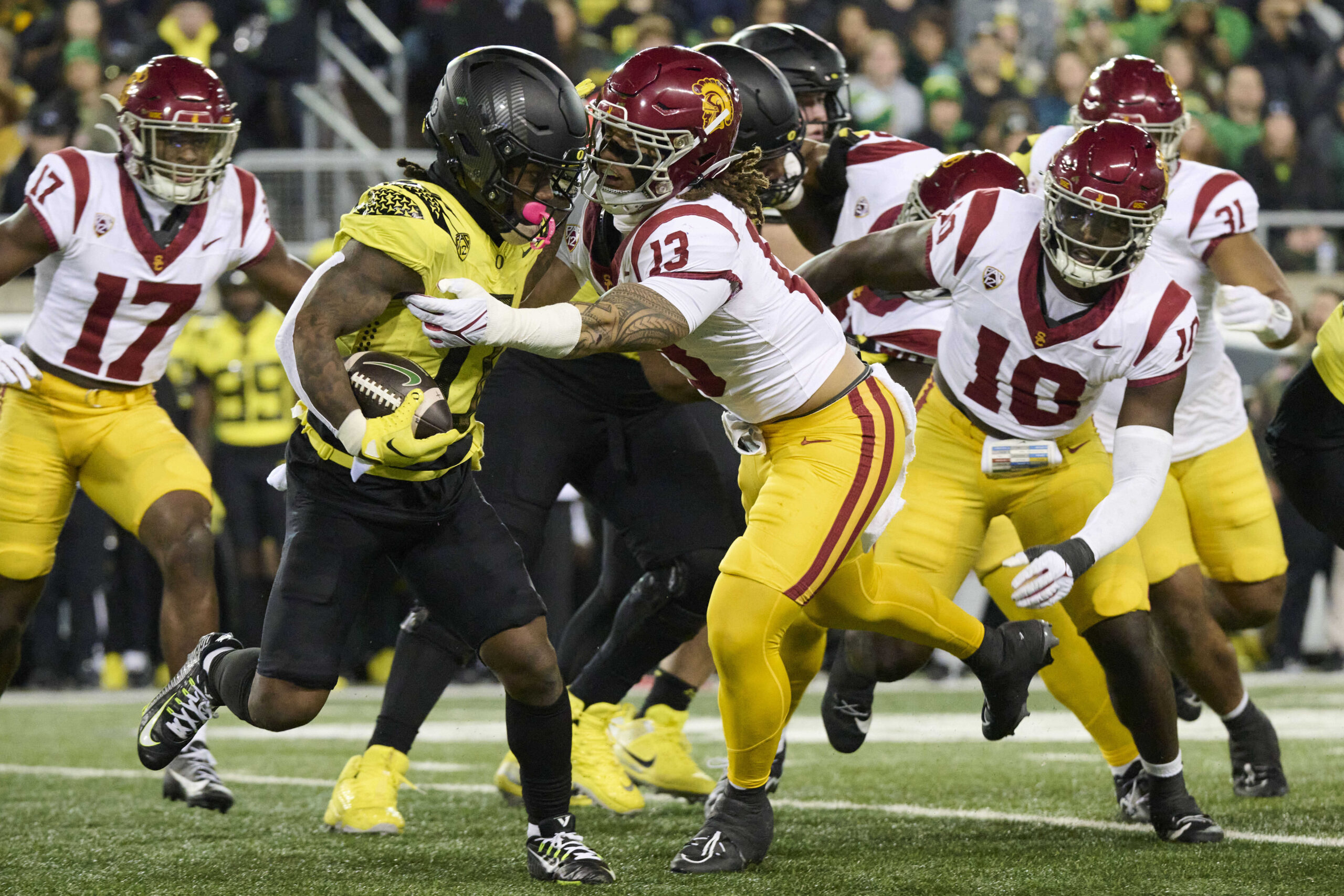Nov 11, 2023; Eugene, Oregon, USA; USC Trojans linebacker Mason Cobb (13) tackles Oregon Ducks running back Bucky Irving (0) at Autzen Stadium.