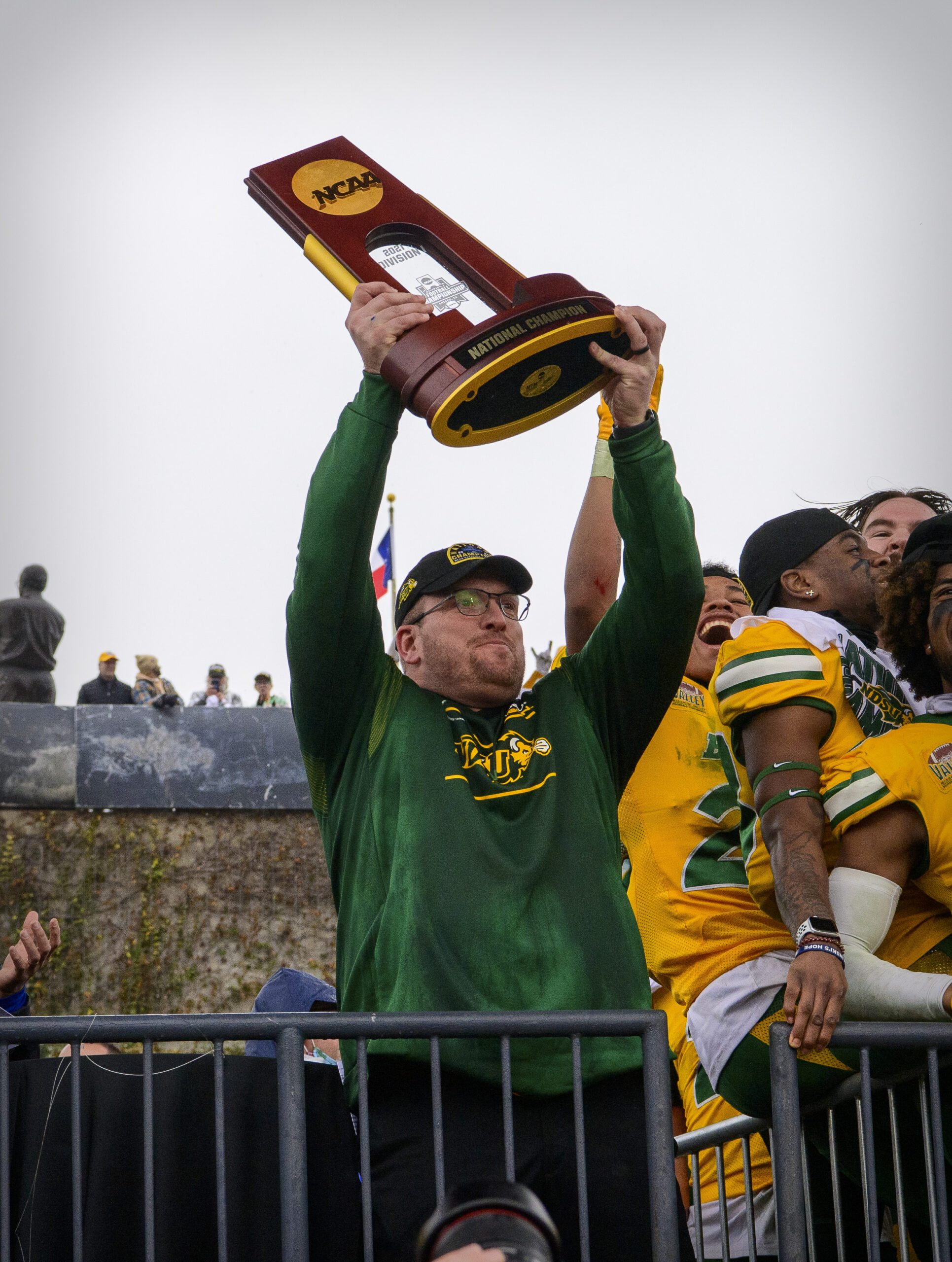 Jan 8, 2022; Frisco, TX, USA; North Dakota State Bison head coach Matt Entz holds up the championship trophy as the North Dakota State Bison team celebrates the win over the Montana State Bobcats in the FCS Championship at Toyota Stadium.