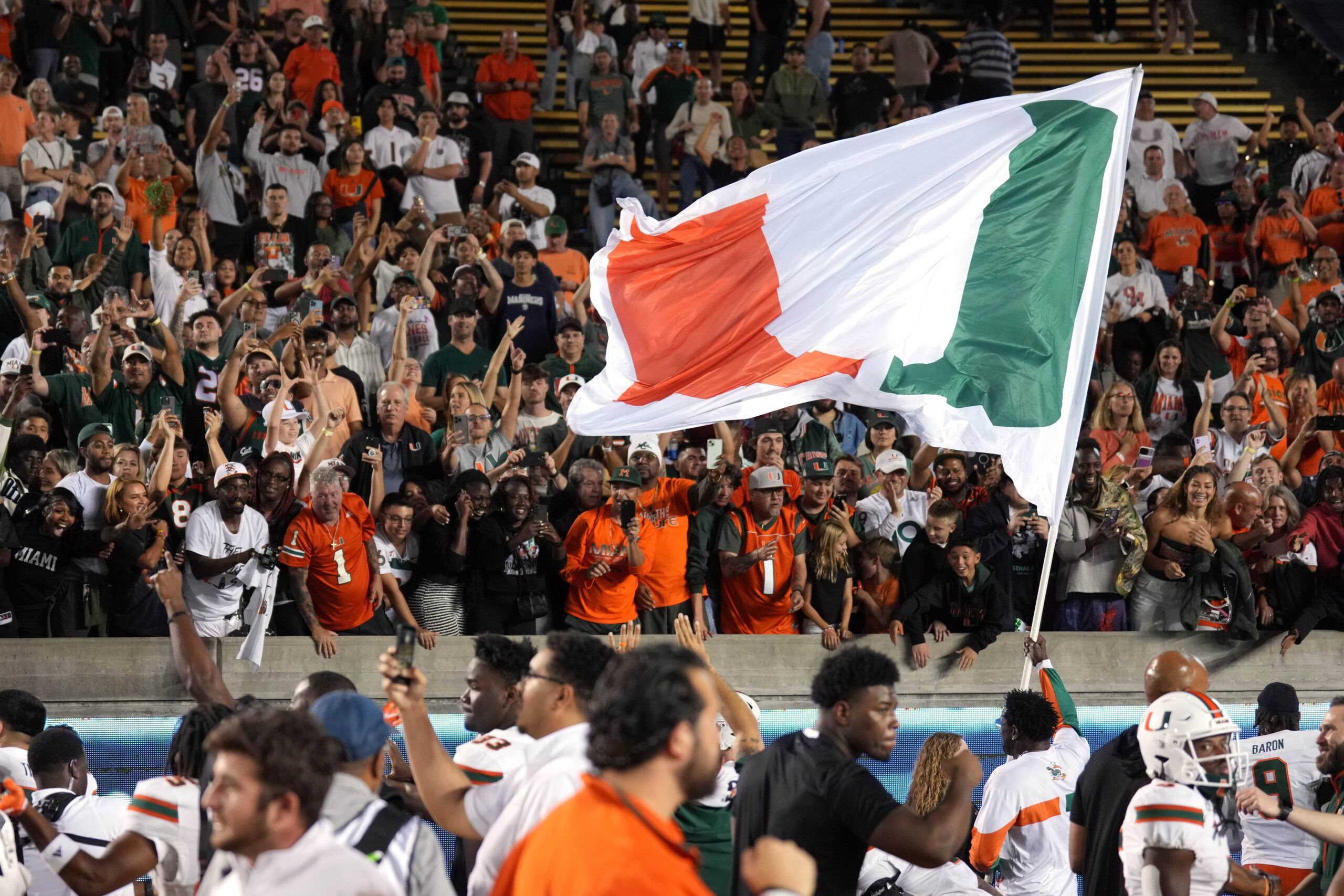 Dec 28, 2023; Bronx, NY, USA; Miami Hurricanes fans cheer before the game against Rutgers Scarlet Knights at Yankee Stadium.