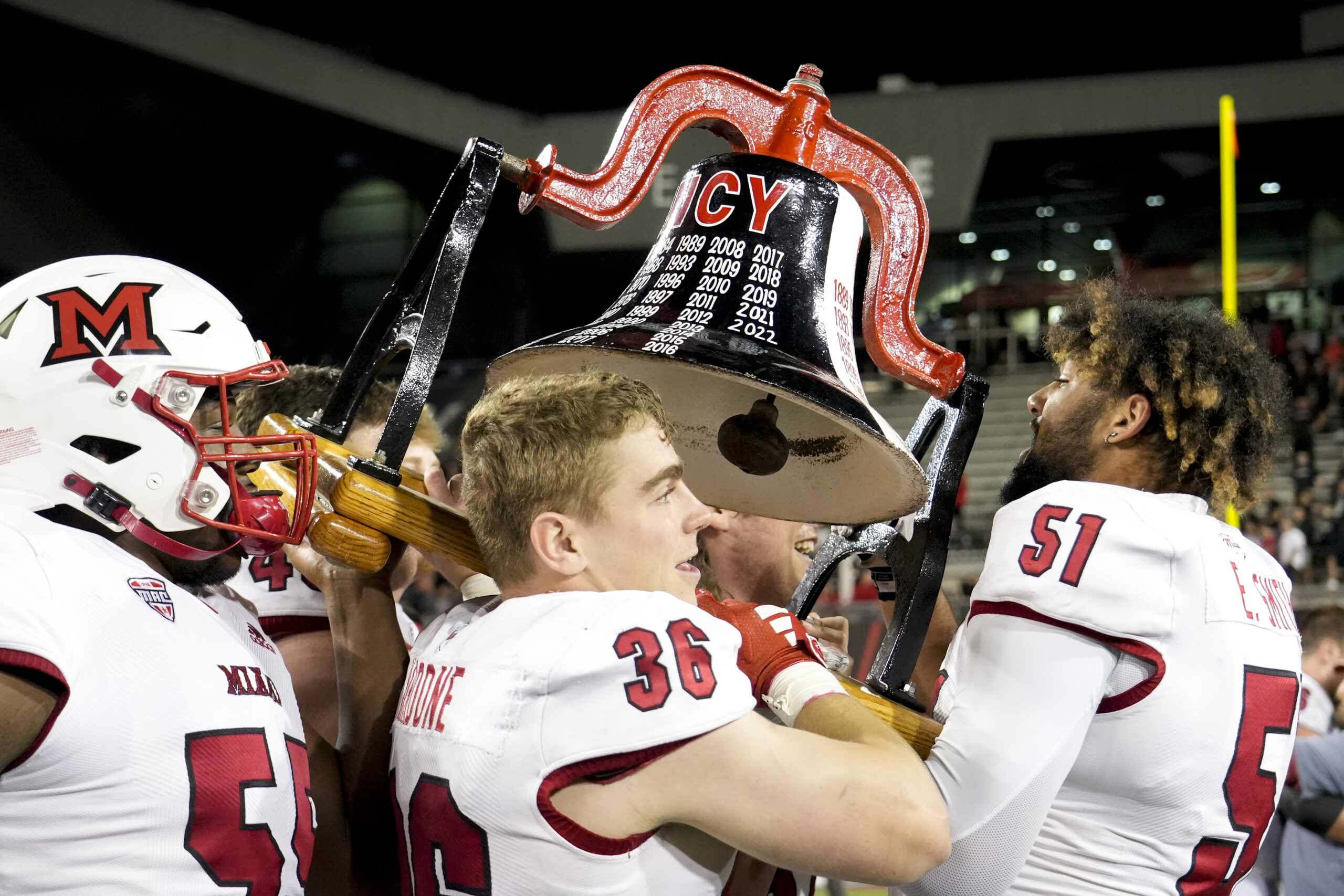 Sept. 16, 2023; Cincinnati, OH; Miami RedHawks hoist the Victory Bell in the air after winning their football game against the rival Cincinnati Bearcats after the NCAA football game between the Cincinnati Bearcats and the Miami RedHawks at Nippert Stadium. 