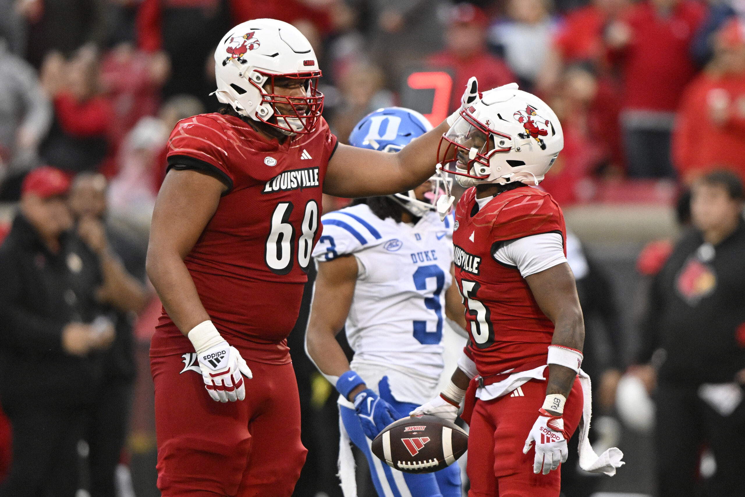 Oct 28, 2023; Louisville, Kentucky, USA; Louisville Cardinals running back Jawhar Jordan (25) celebrates with offensive lineman Michael Gonzalez (68) after making a first down against the Duke Blue Devils during the second half at L&N Federal Credit Union Stadium. Louisville defeated Duke 23-0.