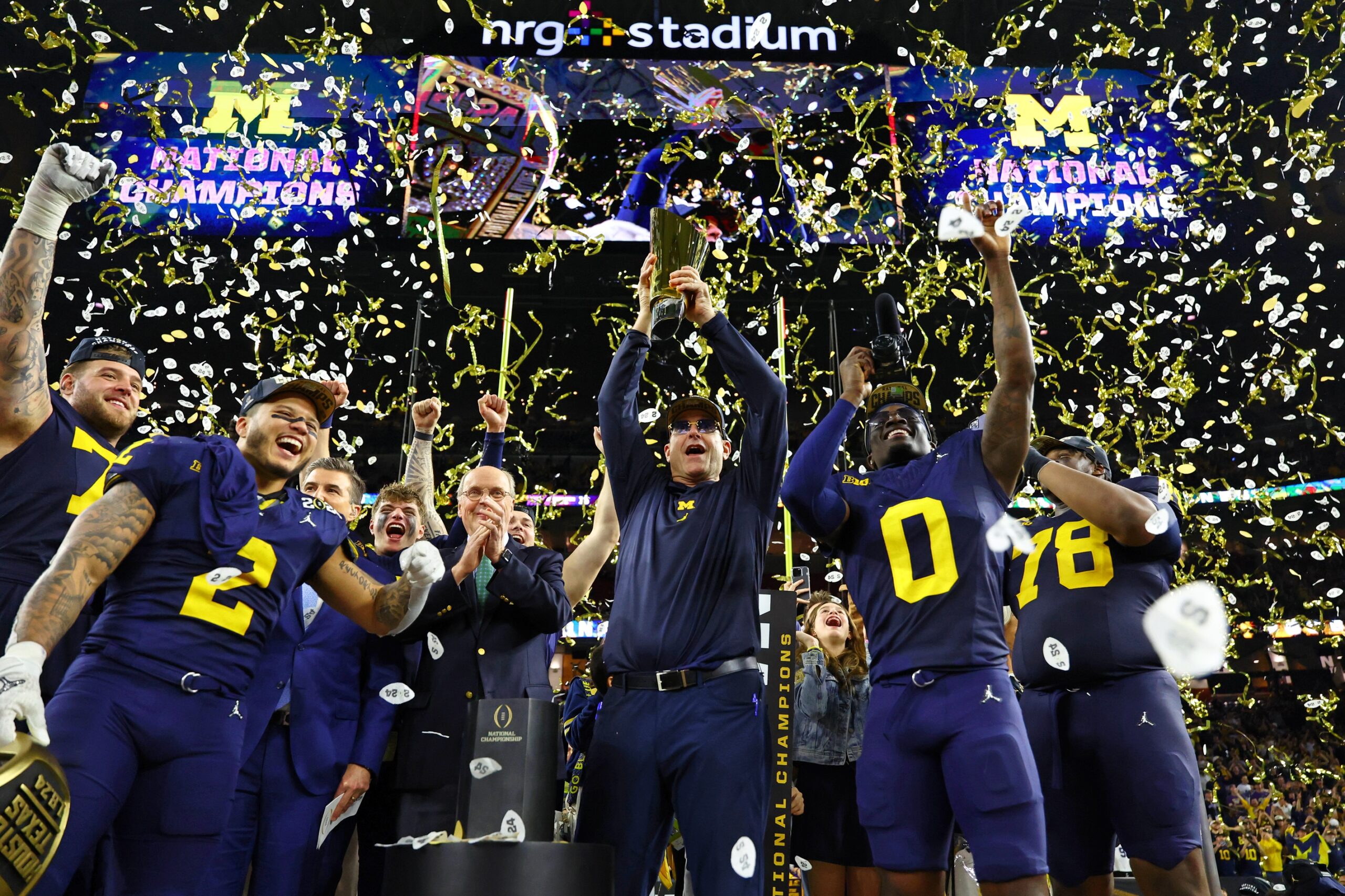 Jan 8, 2024; Houston, TX, USA; Michigan Wolverines head coach Jim Harbaugh holds the National Championship Trophy as he celebrates after winning 2024 College Football Playoff national championship game against the Washington Huskies at NRG Stadium.