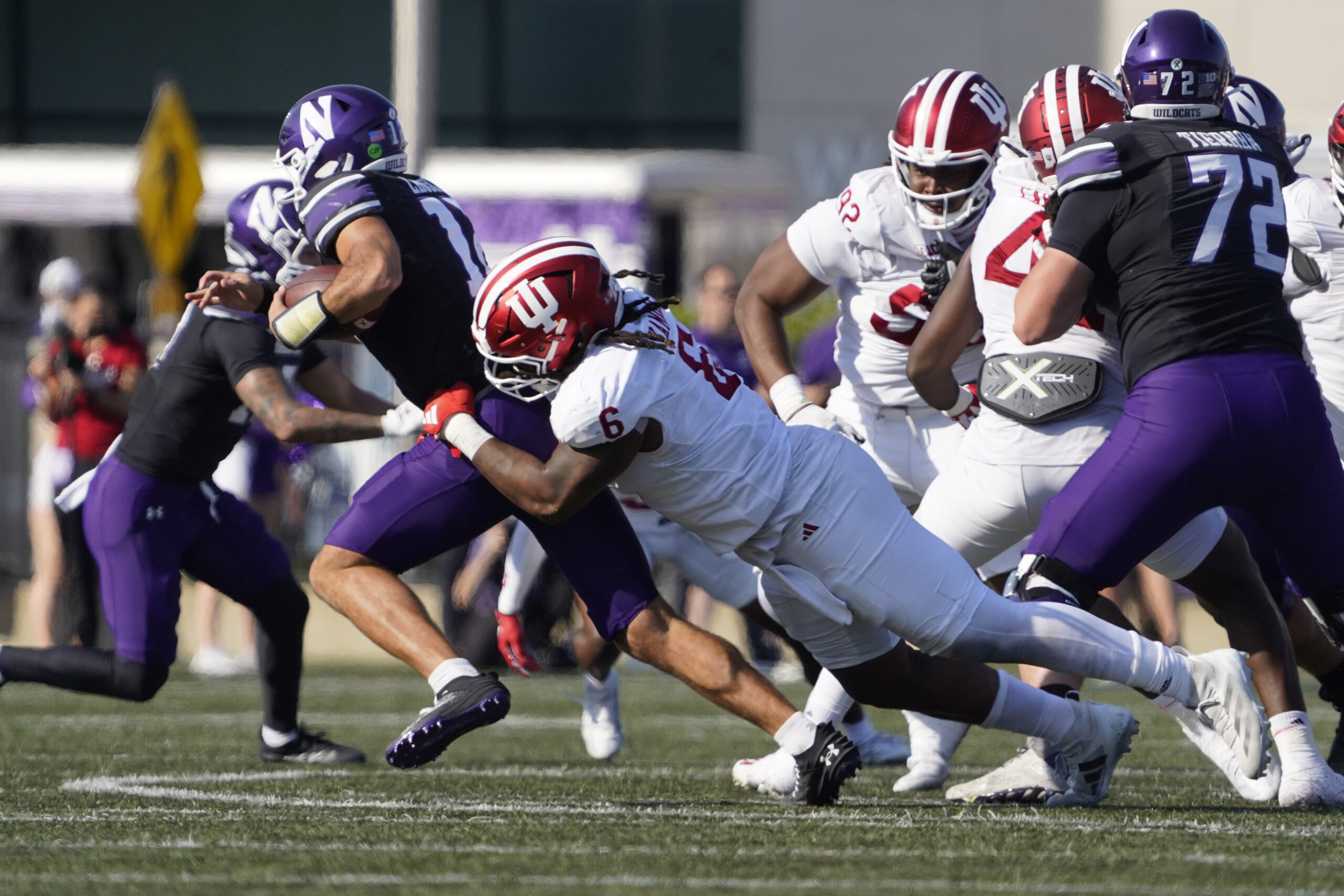 Oct 5, 2024; Evanston, Illinois, USA; Indiana Hoosiers defensive lineman Mikail Kamara (6) sacks Northwestern Wildcats quarterback Jack Lausch (12) during the first half at Lanny and Sharon Martin Stadium. 