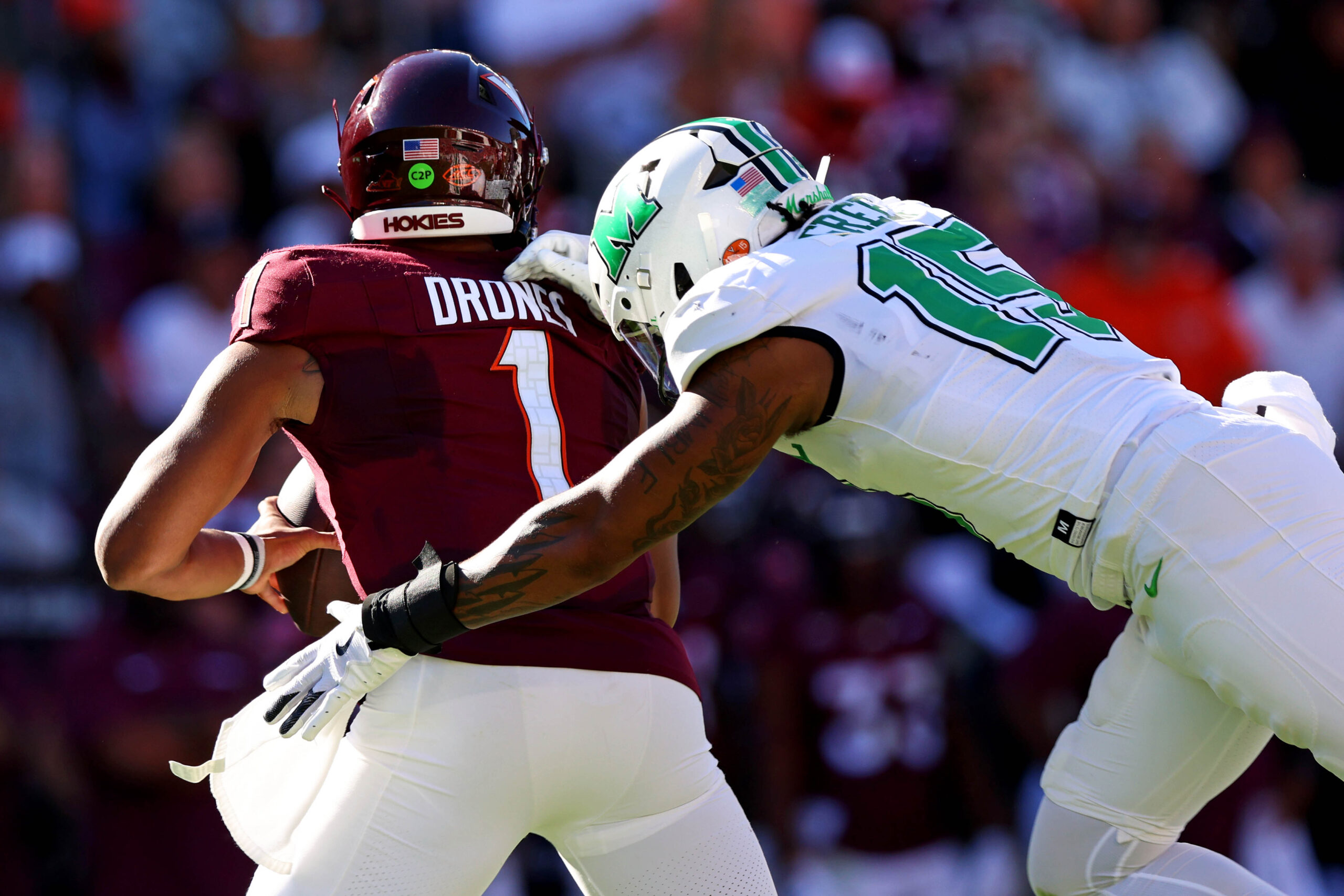 Sep 7, 2024; Blacksburg, Virginia, USA; Marshall Thundering Herd defensive lineman Mike Green (15) sacks Virginia Tech Hokies quarterback Kyron Drones (1) during the first quarter at Lane Stadium.