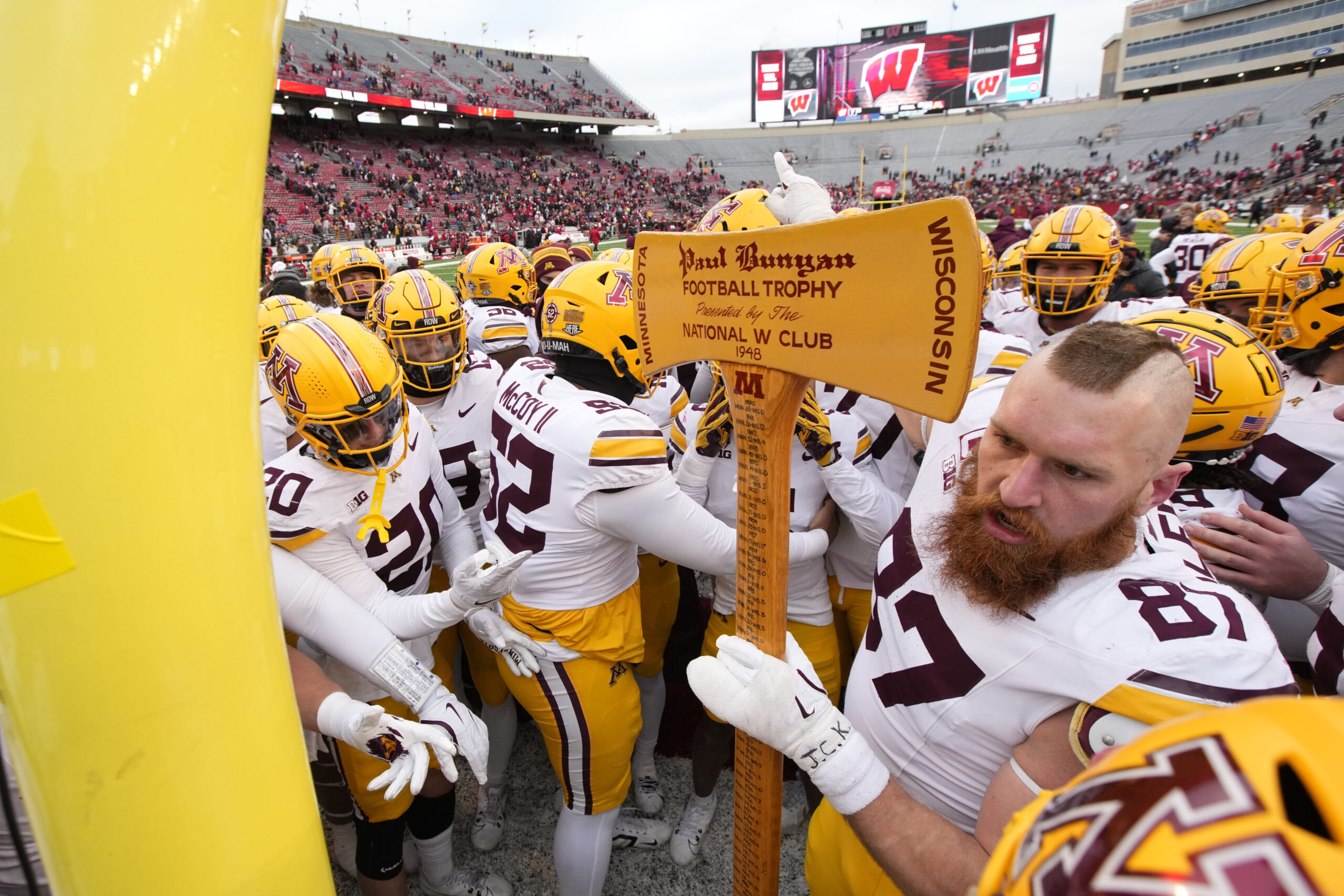 Dec 26, 2023; Detroit, MI, USA; Minnesota Golden Gophers running back Darius Taylor (1) and head coach P.J. Fleck hold up the Quick Lane Bowl trophy after defeating the Bowling Green Falcons at Ford Field. 