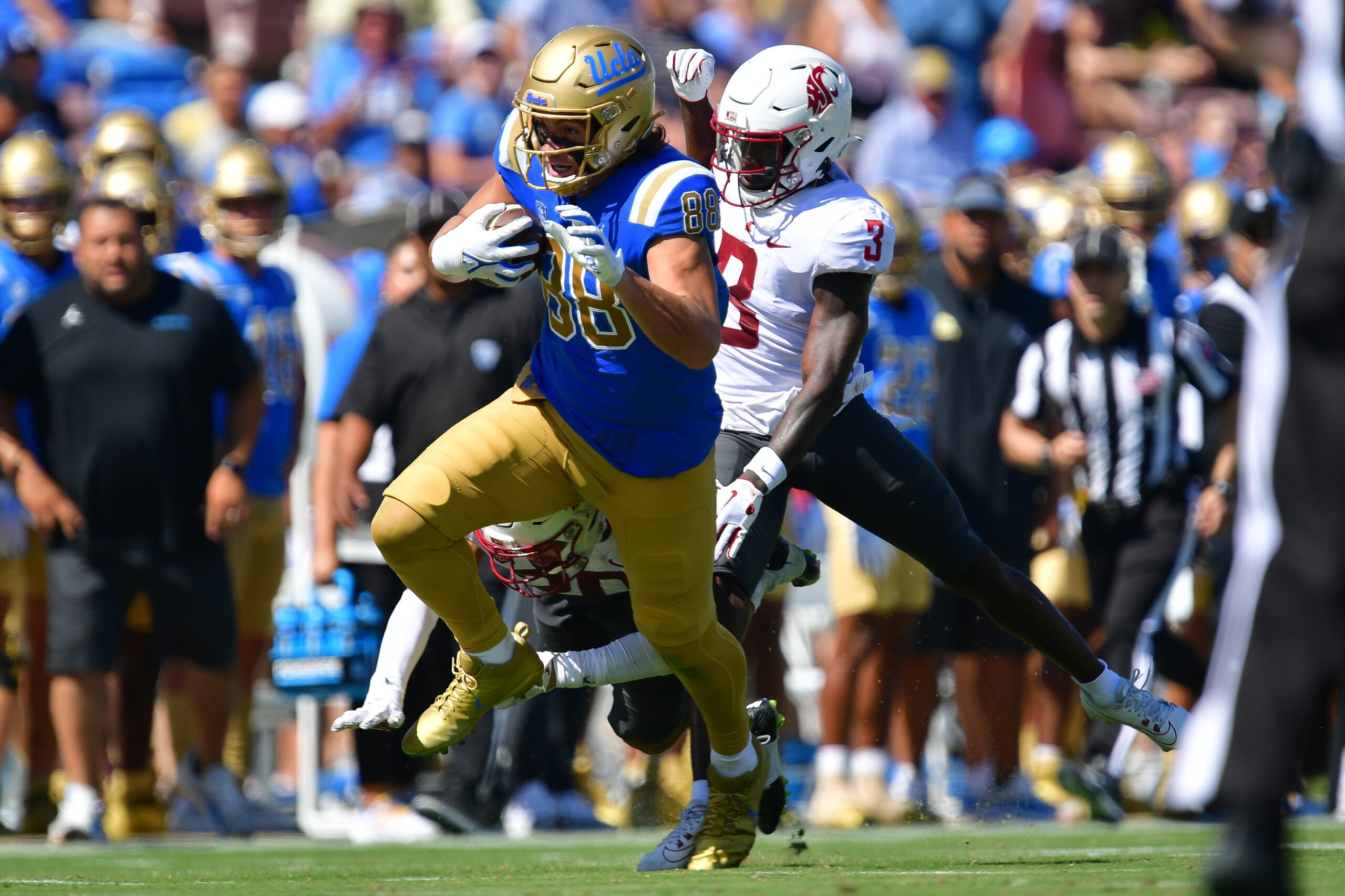 Oct 7, 2023; Pasadena, California, USA; UCLA Bruins tight end Moliki Matavao (88) runs the ball ahead of Washington State Cougars defensive back Cam Lampkin (3) during the first half at Rose Bowl