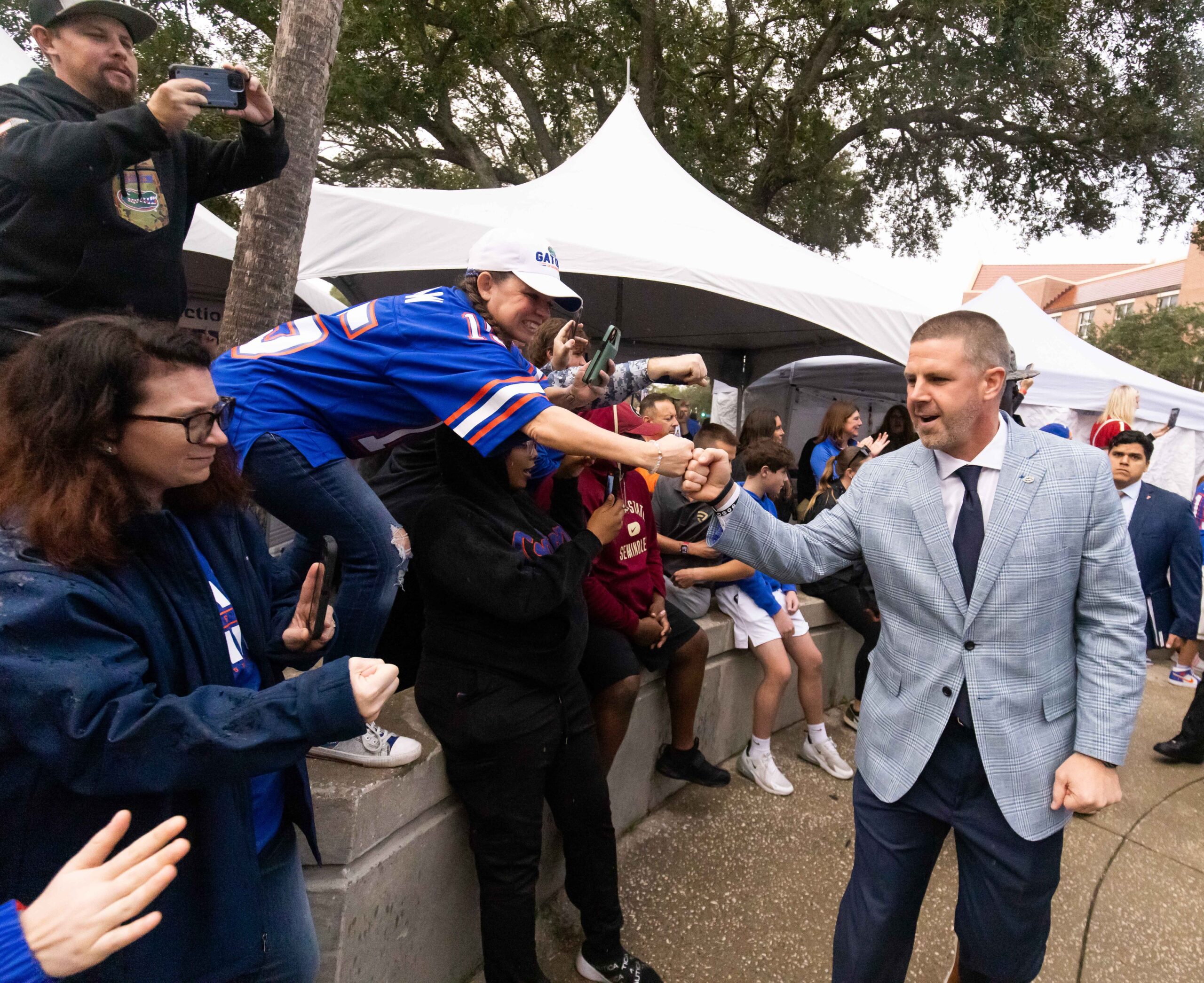 Florida Gators head coach Billy Napier gives fist bumps to fans during Gator Walk at Ben Hill Griffin Stadium in Gainesville, FL on Saturday, November 25, 2023 befoe the game against the Florida State Seminoles.