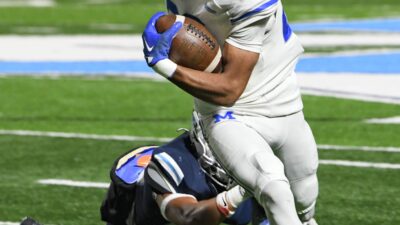 Mandeville's Nate Sheppard runs the ball against Airline in a quarterfinal playoff game Friday 11-24-23.