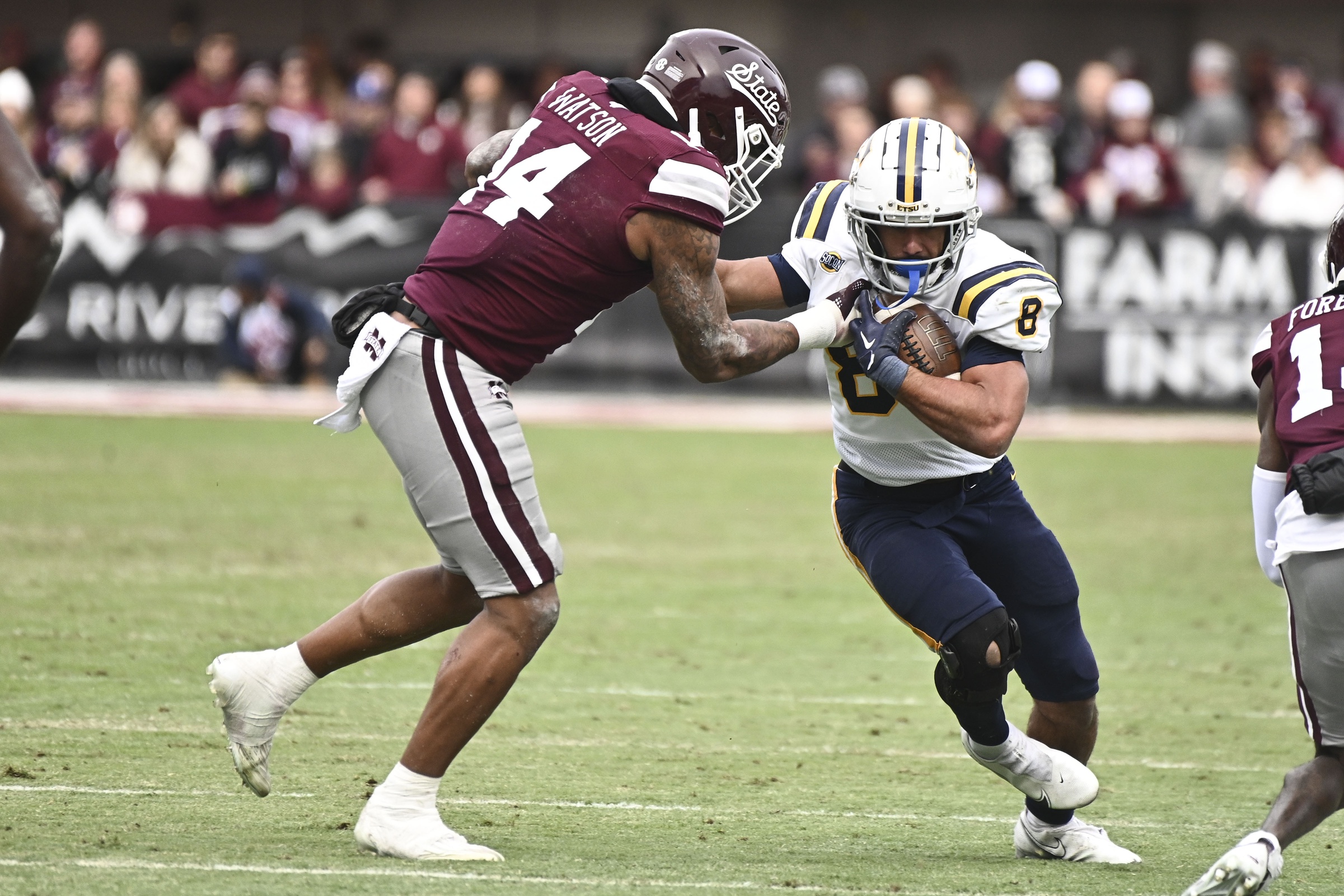 Nov 19, 2022; Starkville, Mississippi, USA; East Tennessee State Buccaneers running back Jacob Saylors (8) runs the ball while defended by Mississippi State Bulldogs linebacker Nathaniel Watson (14) during the first quarter at Davis Wade Stadium at Scott Field.