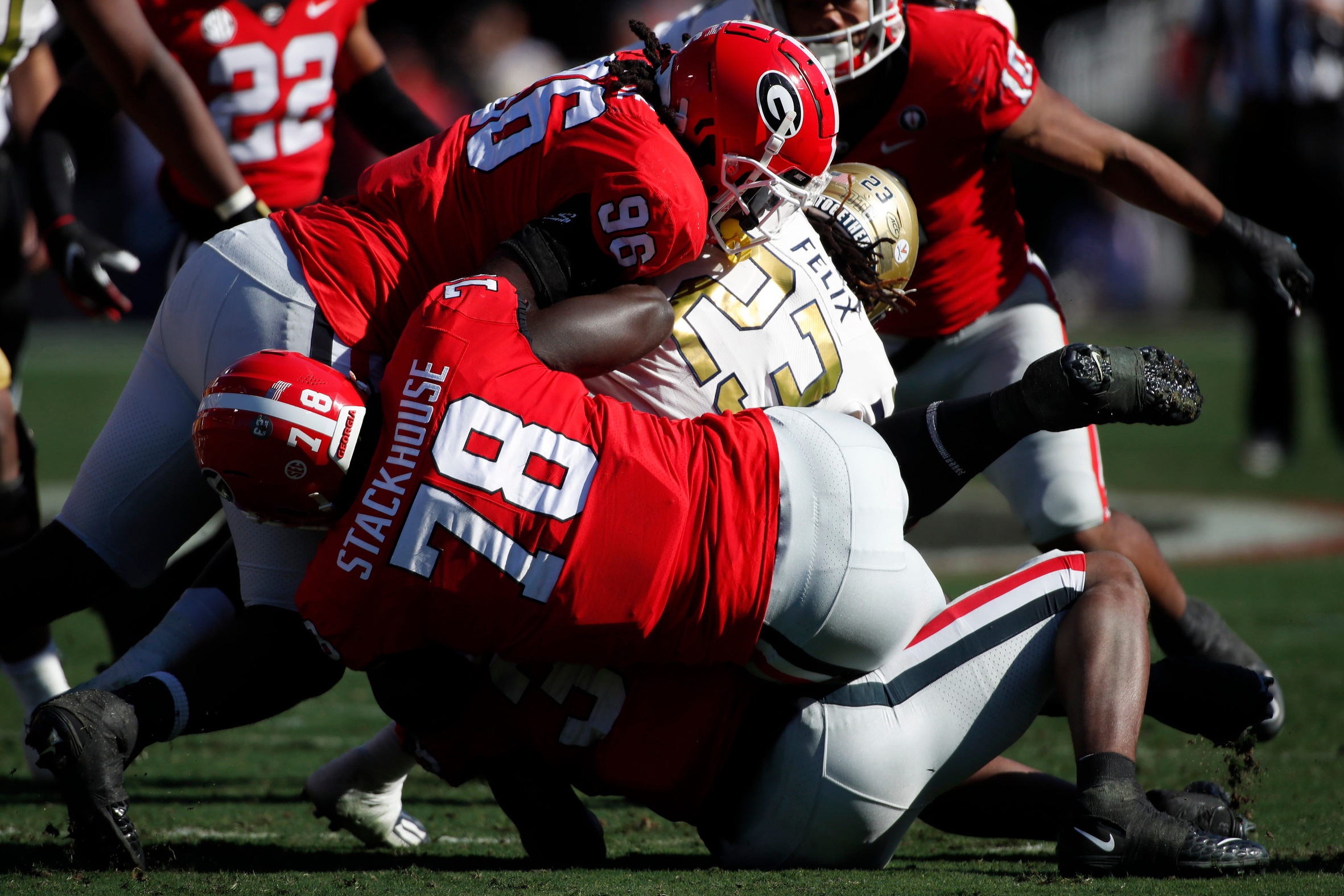 Georgia Tech running back Jamie Felix (23) is stoped by Georgia defensive lineman Nazir Stackhouse (78) and Georgia defensive lineman Zion Logue (96) during the first half of a NCAA college football game between Georgia Tech and Georgia in Athens, Ga., on Saturday, Nov. 26, 2022. 