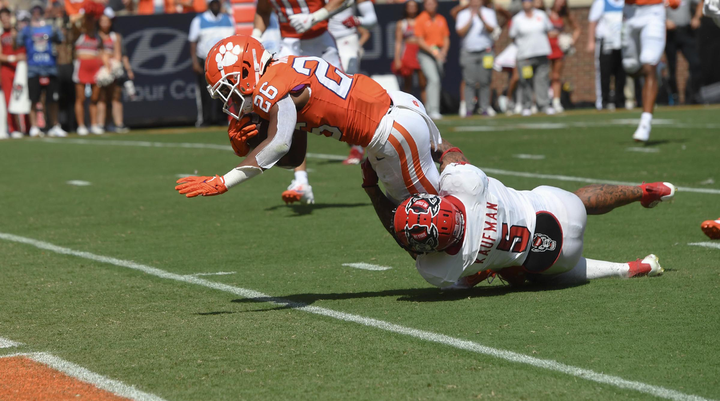 Sep 21, 2024; Clemson, South Carolina, USA; Clemson Tigers running back Jay Haynes (26) scores against North Carolina State Wolfpack safety Donovan Kaufman (5) during the second quarter at Memorial Stadium.
