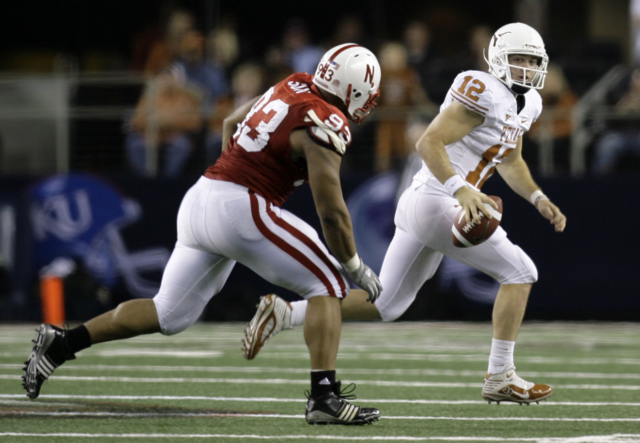 Dec 5, 2009; Arlington, TX, USA; Texas Longhorns quarterback Colt McCoy (12) avoids the rush of Nebraska Cornhuskers defensive tackle Ndamukong Suh (93) in the second quarter of the 2009 Big 12 championship game at Cowboys Stadium.