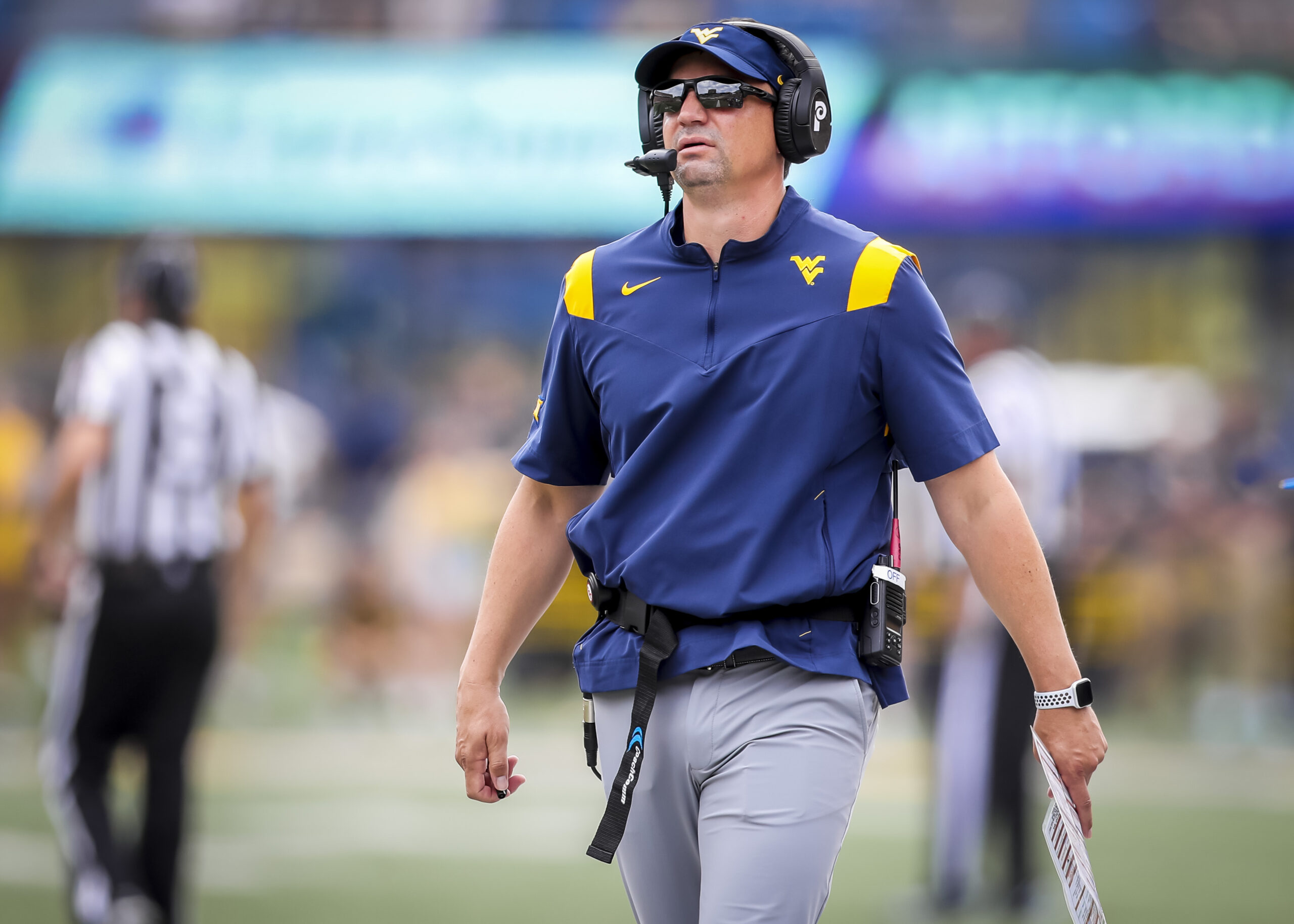 Sep 21, 2024; Morgantown, West Virginia, USA; West Virginia Mountaineers head coach Neal Brown walks along the sidelines during the second quarter against the Kansas Jayhawks at Mountaineer Field at Milan Puskar Stadium.