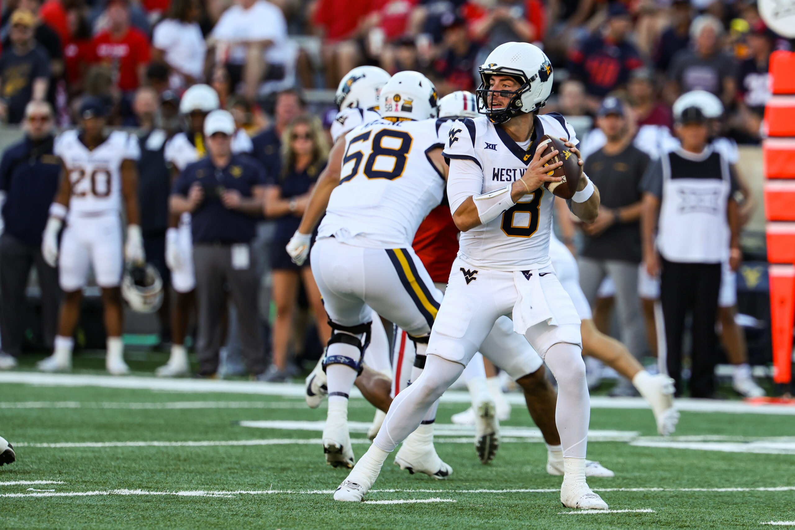 Oct 26, 2024; Tucson, Arizona, USA; West Virginia Mountaineers quarterback Nicco Marchiol (8) looks to throw the ball during the first quarter against the Arizona Wildcats at Arizona Stadium.