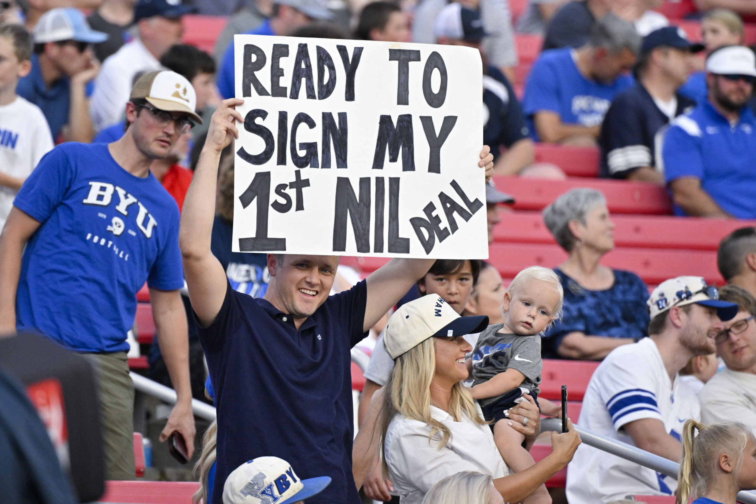 Sep 6, 2024; Dallas, Texas, USA; A view of a fan holding up an NIL sign during the first half of the game between the Southern Methodist Mustangs and the Brigham Young Cougars at Gerald J. Ford Stadium