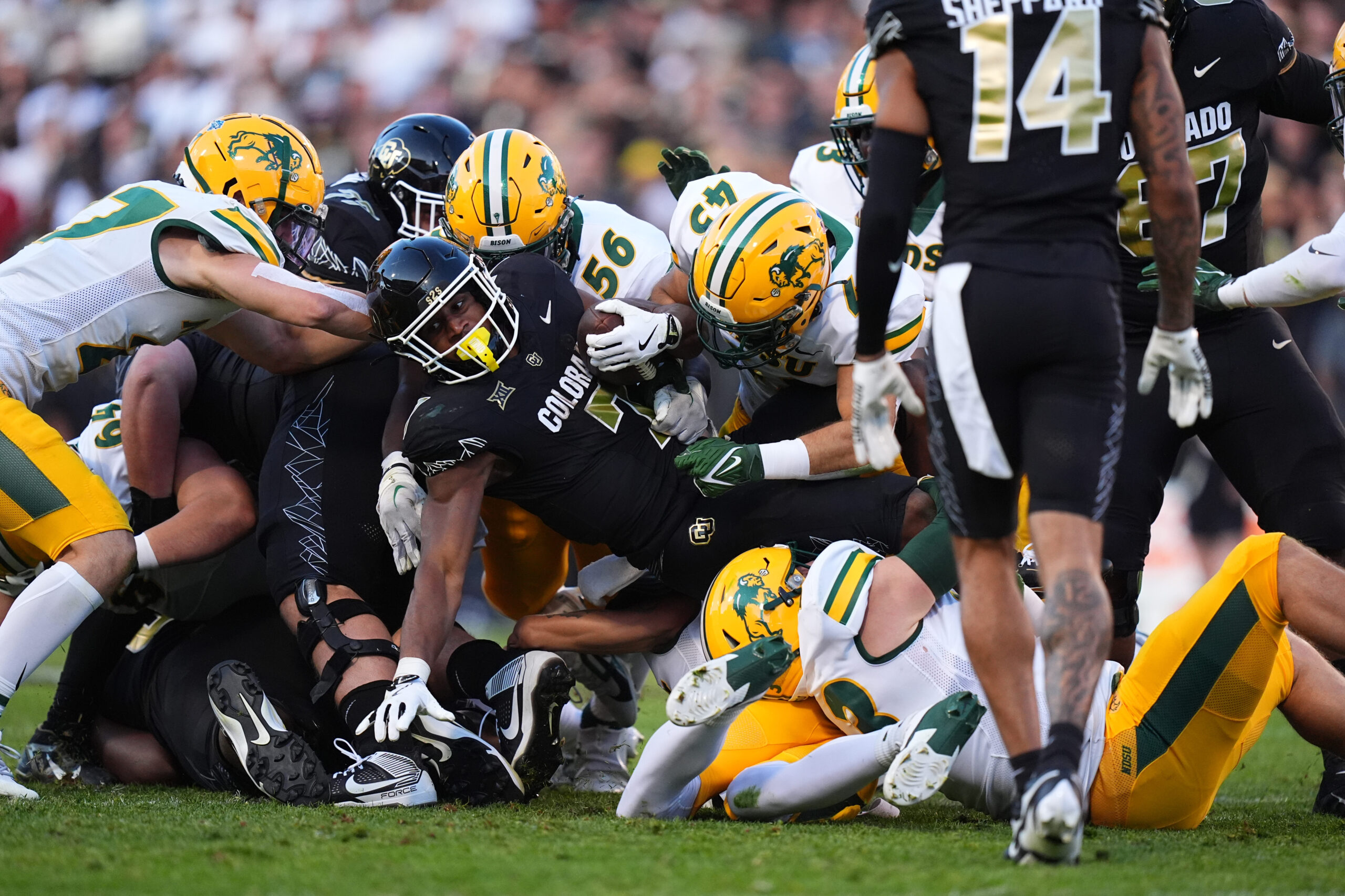 Aug 29, 2024; Boulder, Colorado, USA; Colorado Buffaloes running back Dallan Hayden (7) is stopped on fourth down by North Dakota State Bison defensive end Loshiaka Roques (56) and linebacker Logan Kopp (43) in the second quarter at Folsom Field.