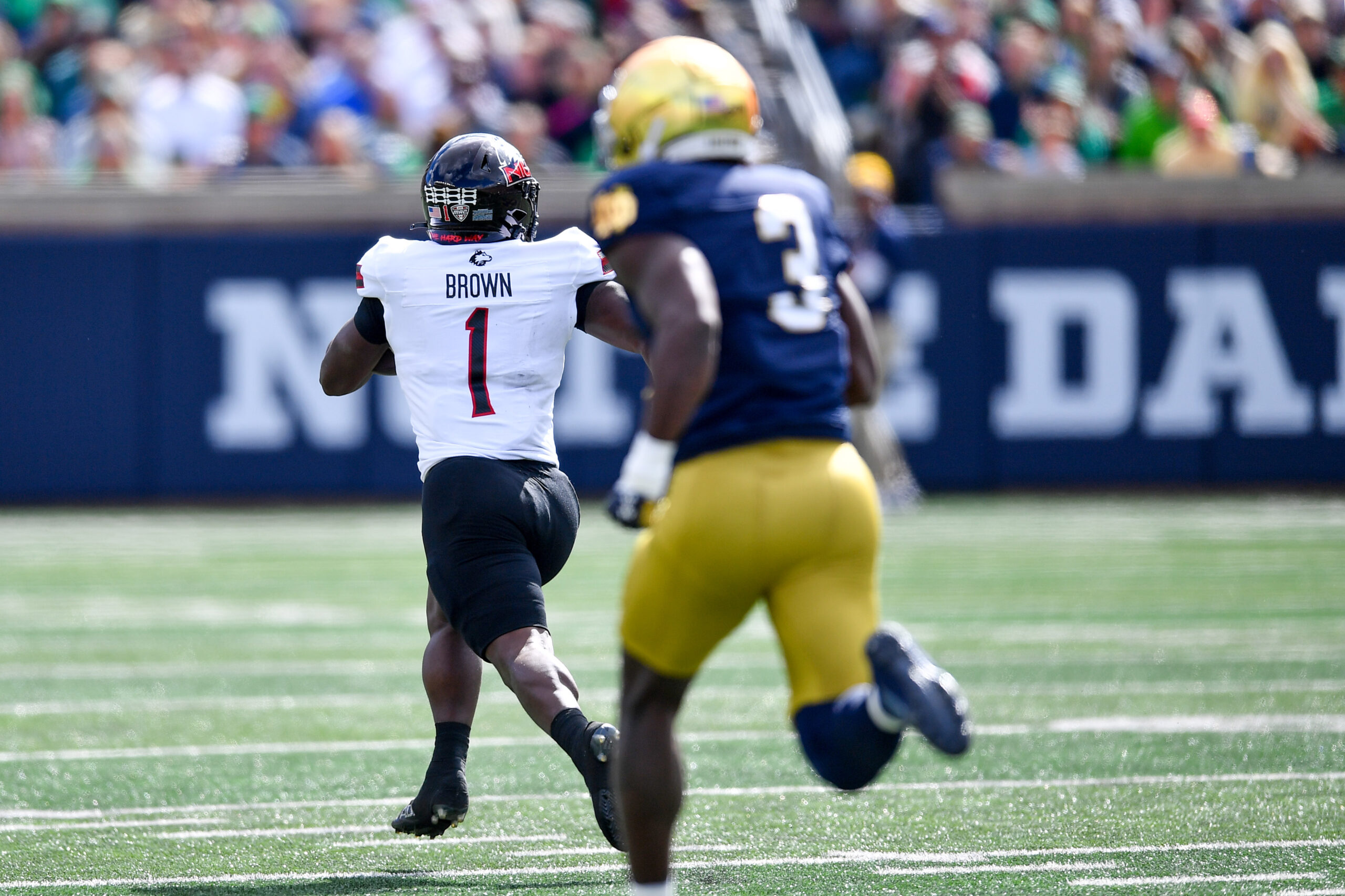 Sep 7, 2024; South Bend, Indiana, USA; Northern Illinois Huskies running back Antario Brown (1) catches a pass for a touchdown as Notre Dame Fighting Irish linebacker Jaylen Sneed (3) pursues in the first quarter at Notre Dame Stadium.