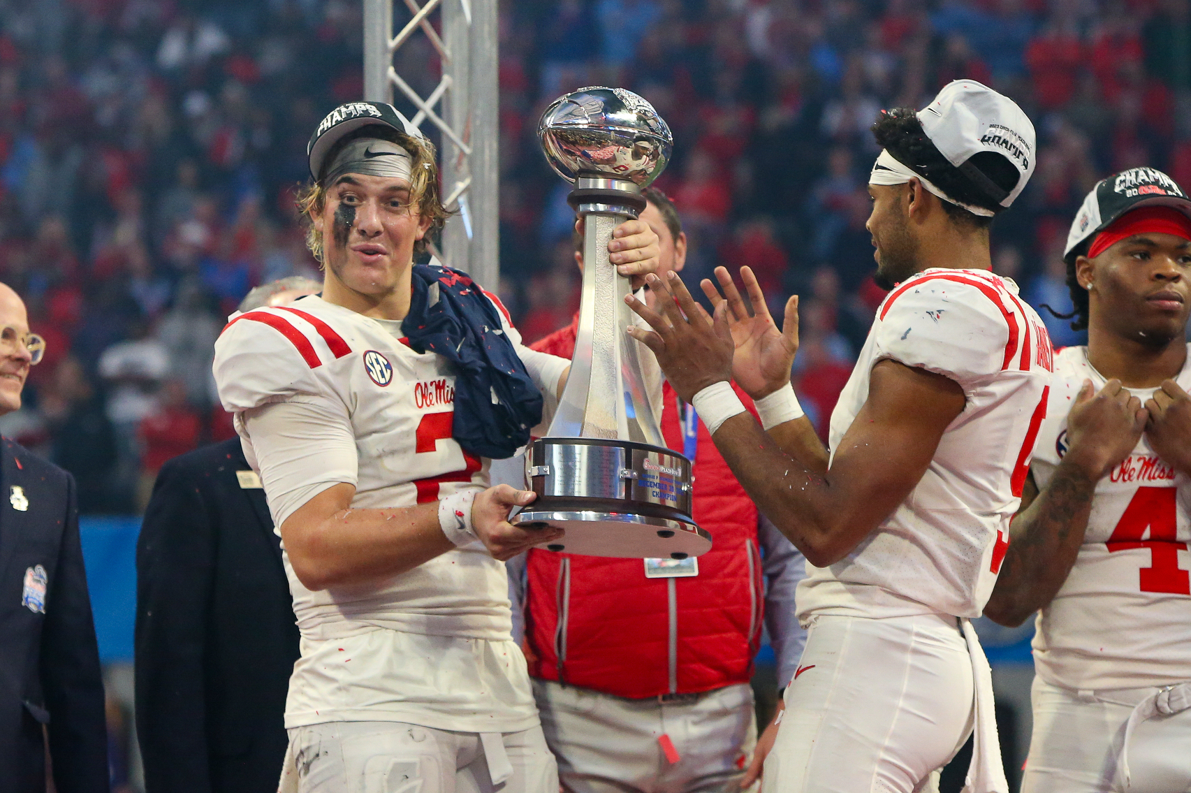 Dec 30, 2023; Atlanta, GA, USA; Mississippi Rebels quarterback Jaxson Dart (2) holds up the Peach Bowl trophy after a victory against the Penn State Nittany Lions at Mercedes-Benz Stadium. 