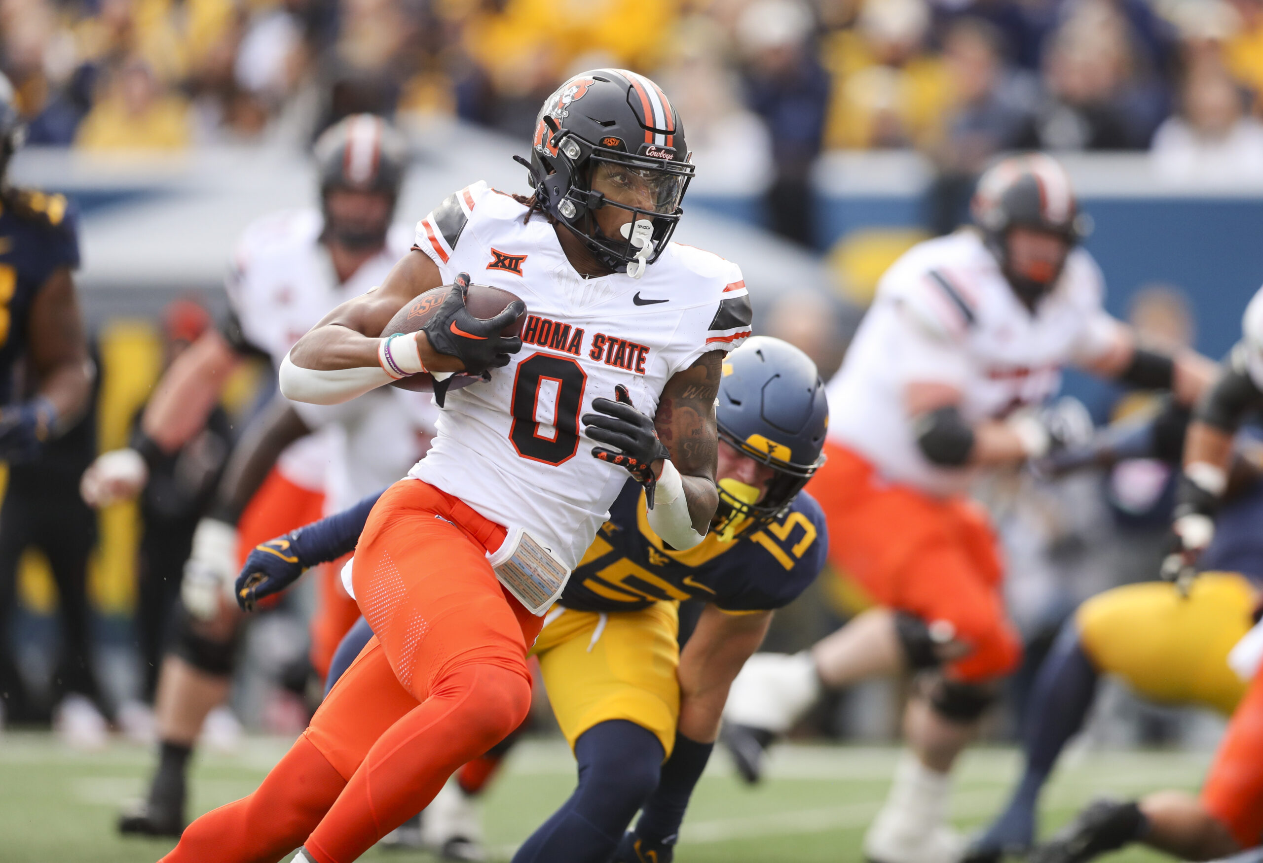 Oct 21, 2023; Morgantown, West Virginia, USA; Oklahoma State Cowboys running back Ollie Gordon II (0) runs for a touchdown during the first quarter against the West Virginia Mountaineers at Mountaineer Field at Milan Puskar Stadium.