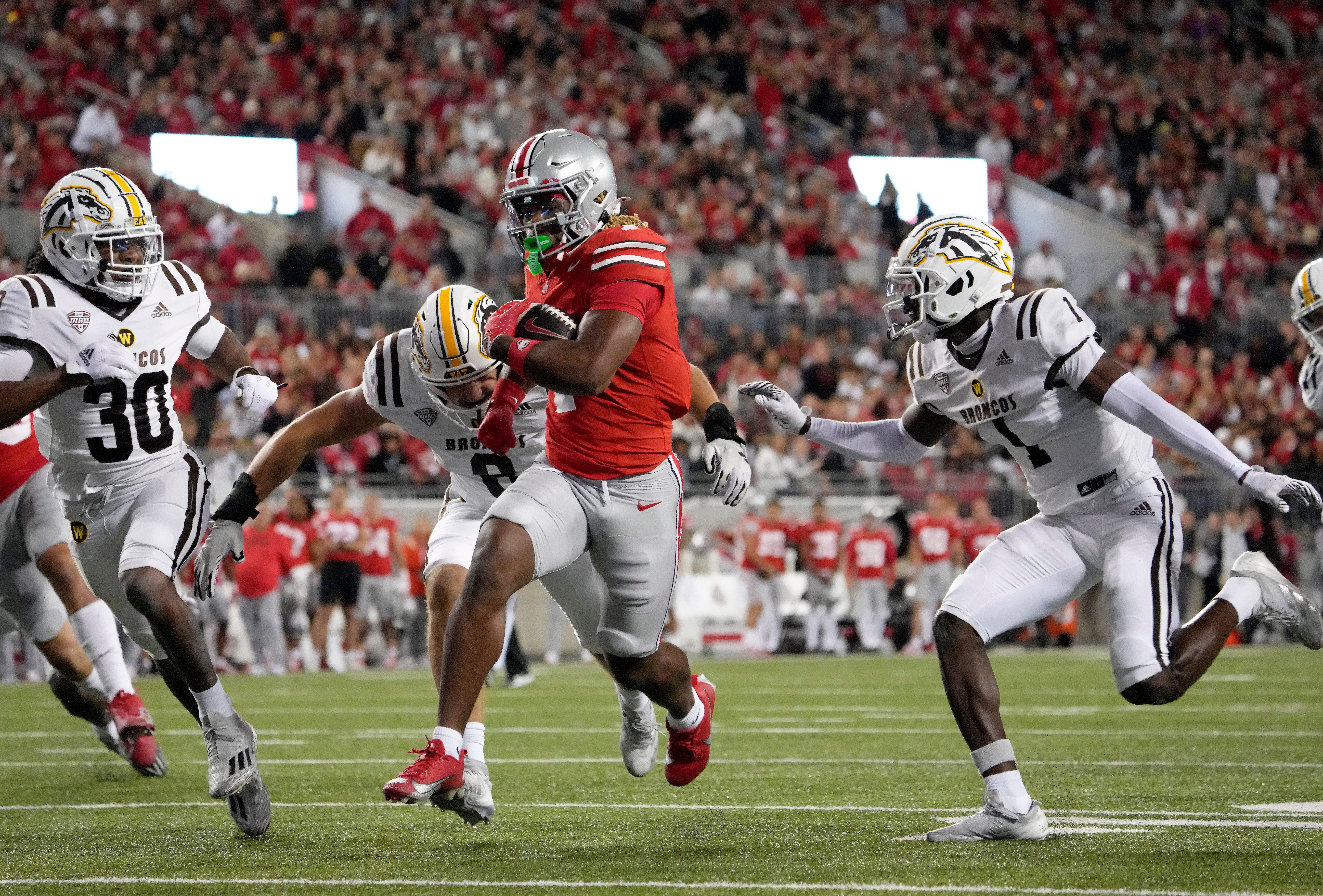 Sept. 21, 2024; Columbus, Ohio, USA; Ohio State Buckeyes running back Quinshon Judkins (1) outruns Marshall Thundering Herd defensive back Jadarius Green-McKnight (4) during the second half of an NCAA Division I football game at Ohio Stadium on Saturday.