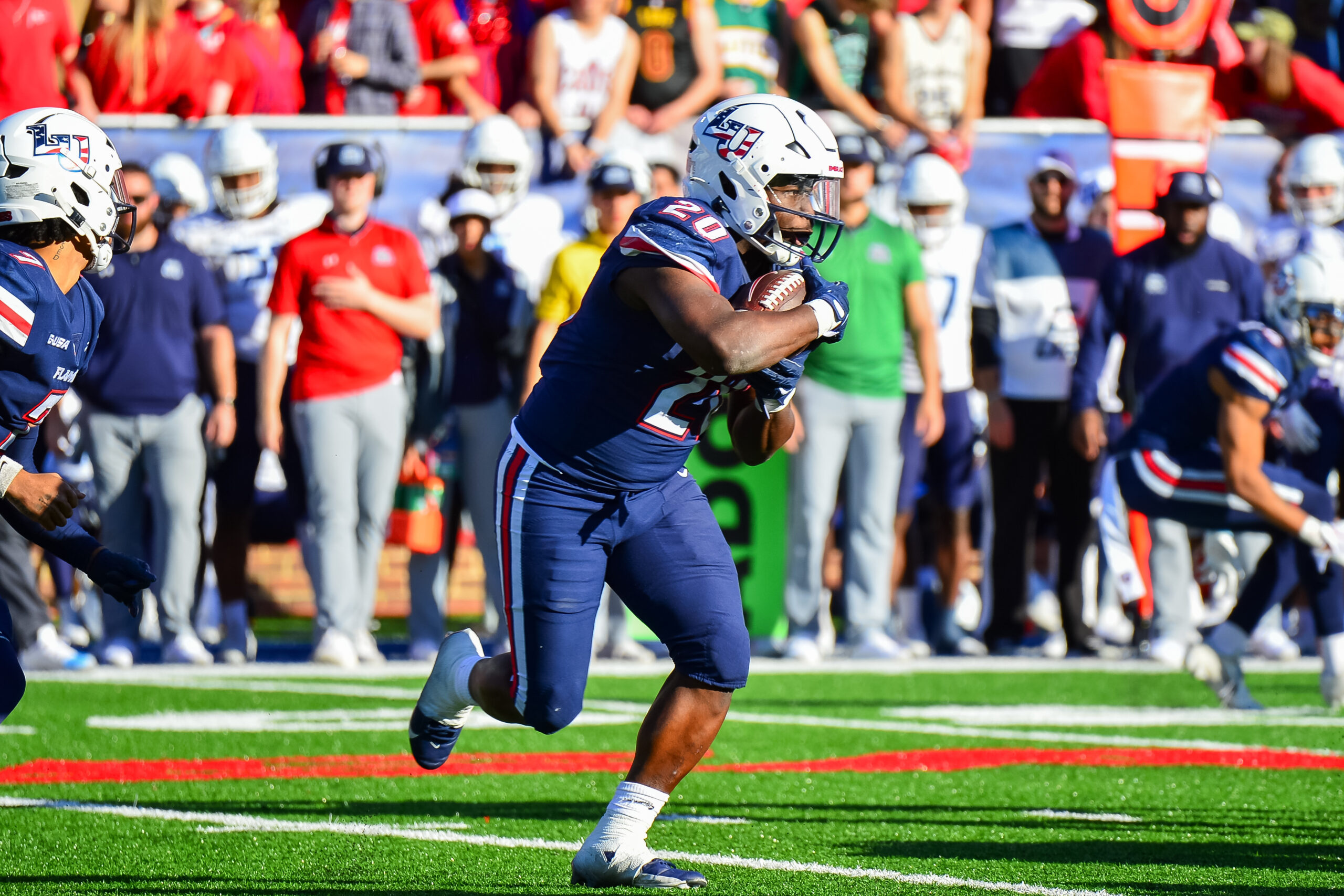 Nov 11, 2023; Lynchburg, Virginia, USA; Liberty Flames running back Quinton Cooley (20) runs the ball in the third quarter at Williams Stadium.