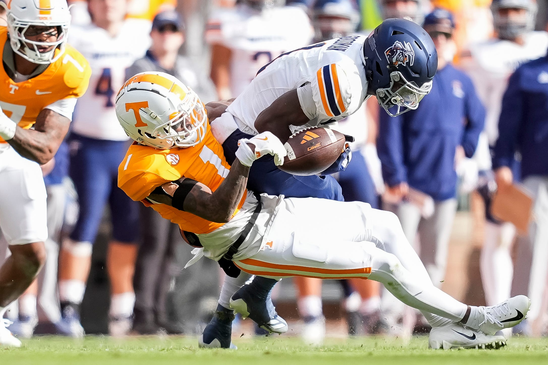 Tennessee defensive back Rickey Gibson III (1) strips the ball away from UTEP wide receiver Trey Goodman (1) during a college football game between Tennessee and UTEP at Neyland Stadium in Knoxville, Tenn., Saturday, Nov. 23, 2024.
